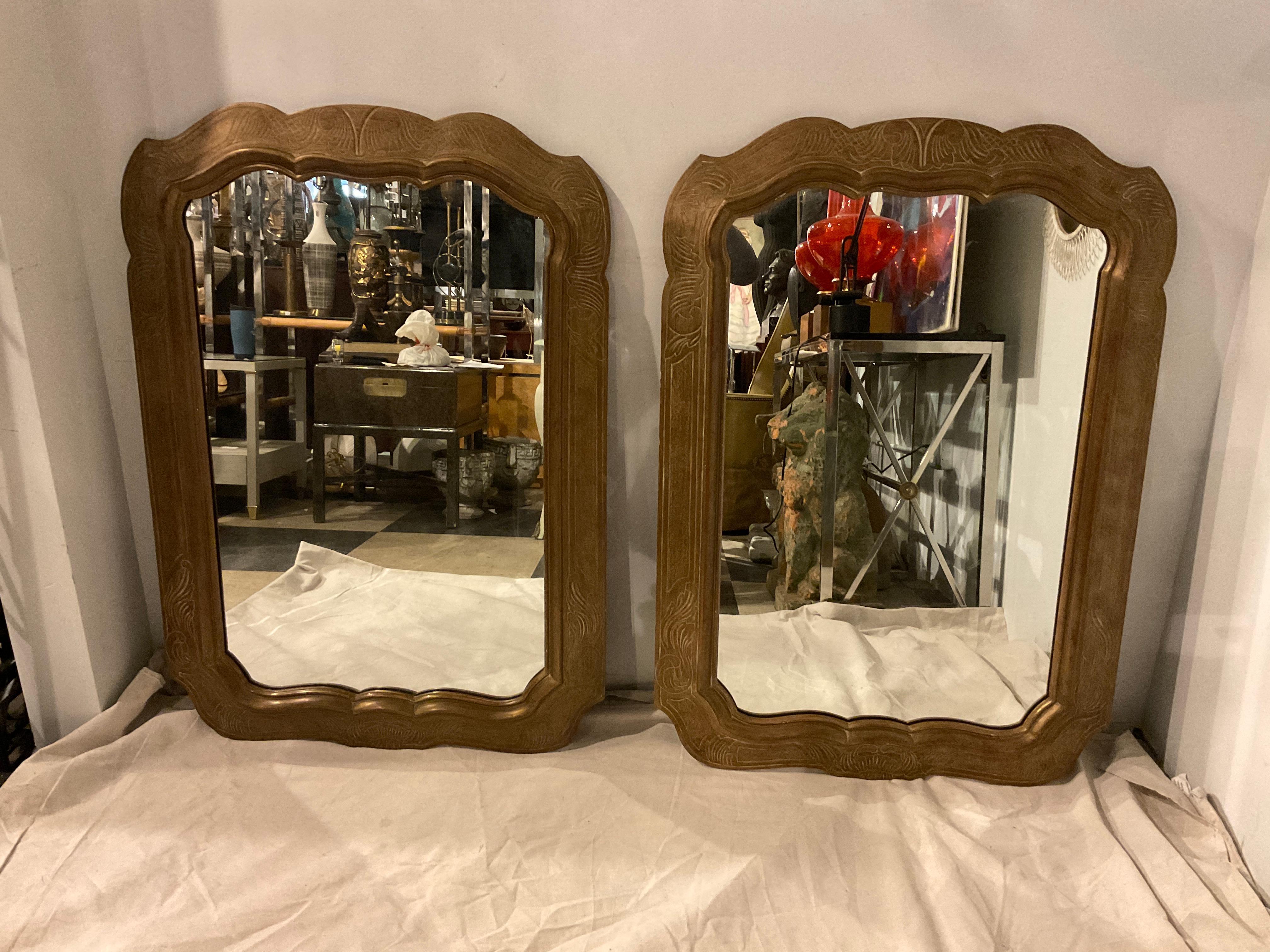 Pair of 1950s wood decorative mirrors. Etched design in frame.