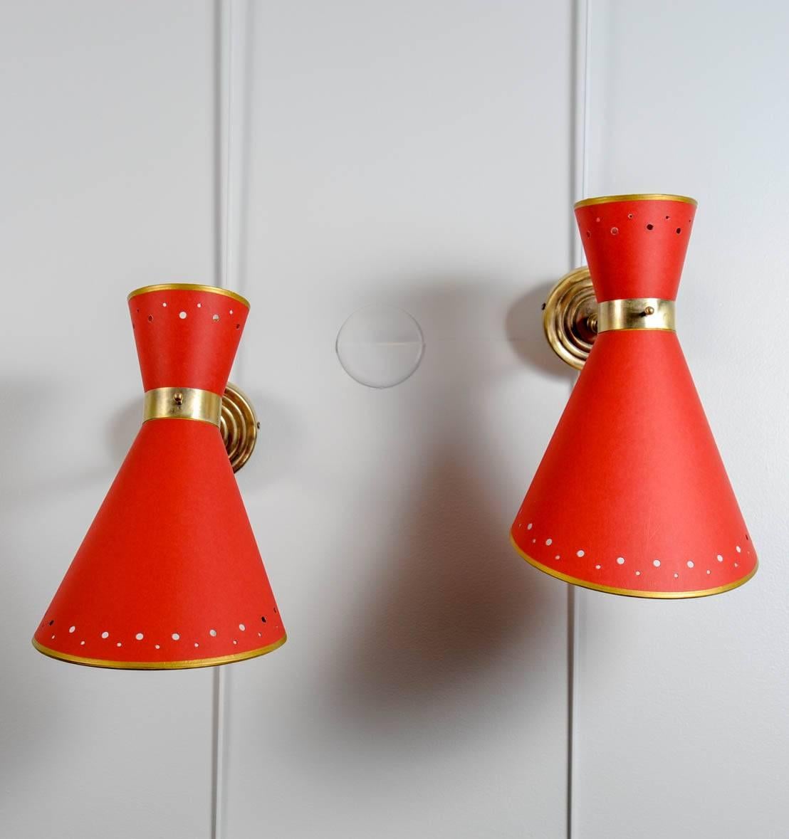 Pair of sconces, brass with diabolo shades in red paper.
The shades are new with the same design and form that the older,
circa 1950.