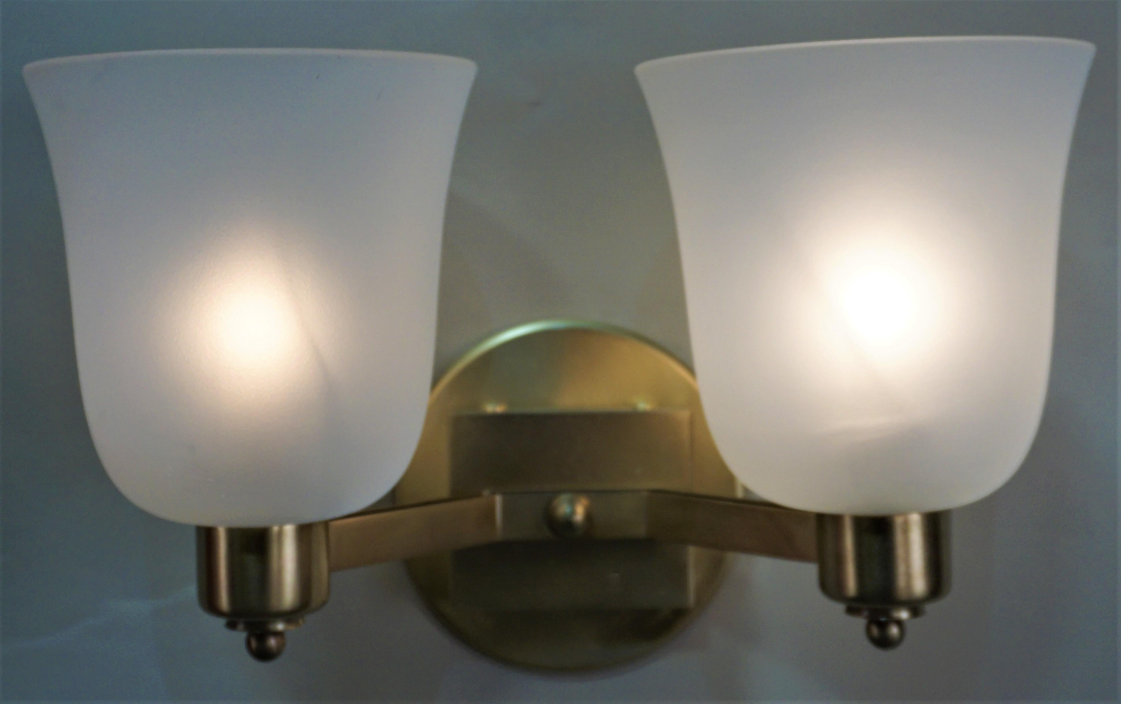 Simple but elegant pair of double arm bronze and frost glass wall sconces signed by Jean Perzel.
Round backplate is 4.75