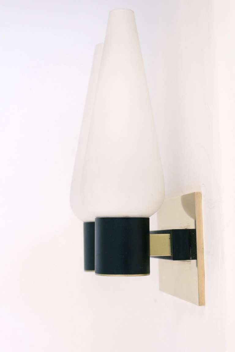 Pair of 1950s double sconces by Maison Arlus.
Opaline glass shade and brass mounting.