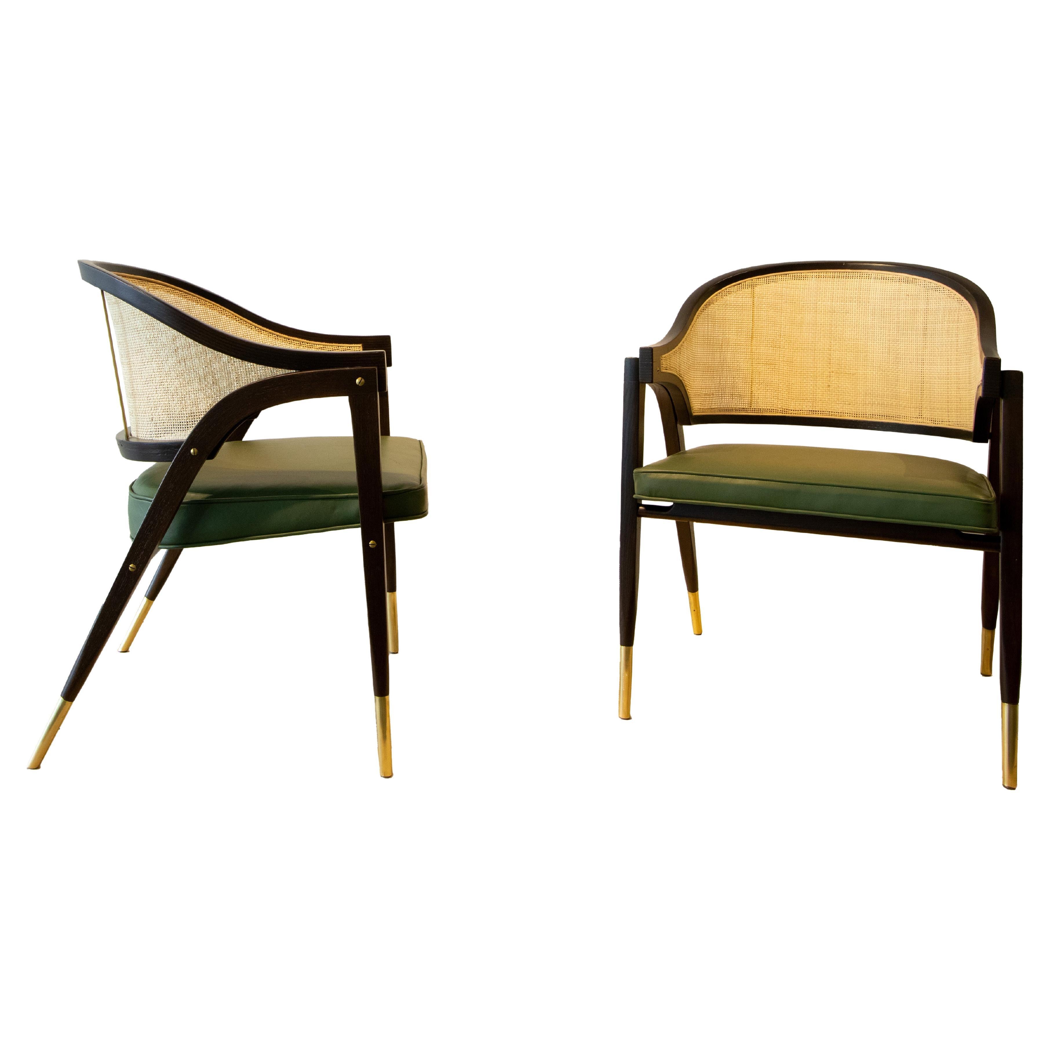 A pair of Model 5480 brass stiletto cane chairs designed by Edward Wormley for Dunbar Furniture. Details are everything, and nothing was skipped in this design. With exposed brass hardware, Brass stretchers, bentwood legs that curve into the arm,