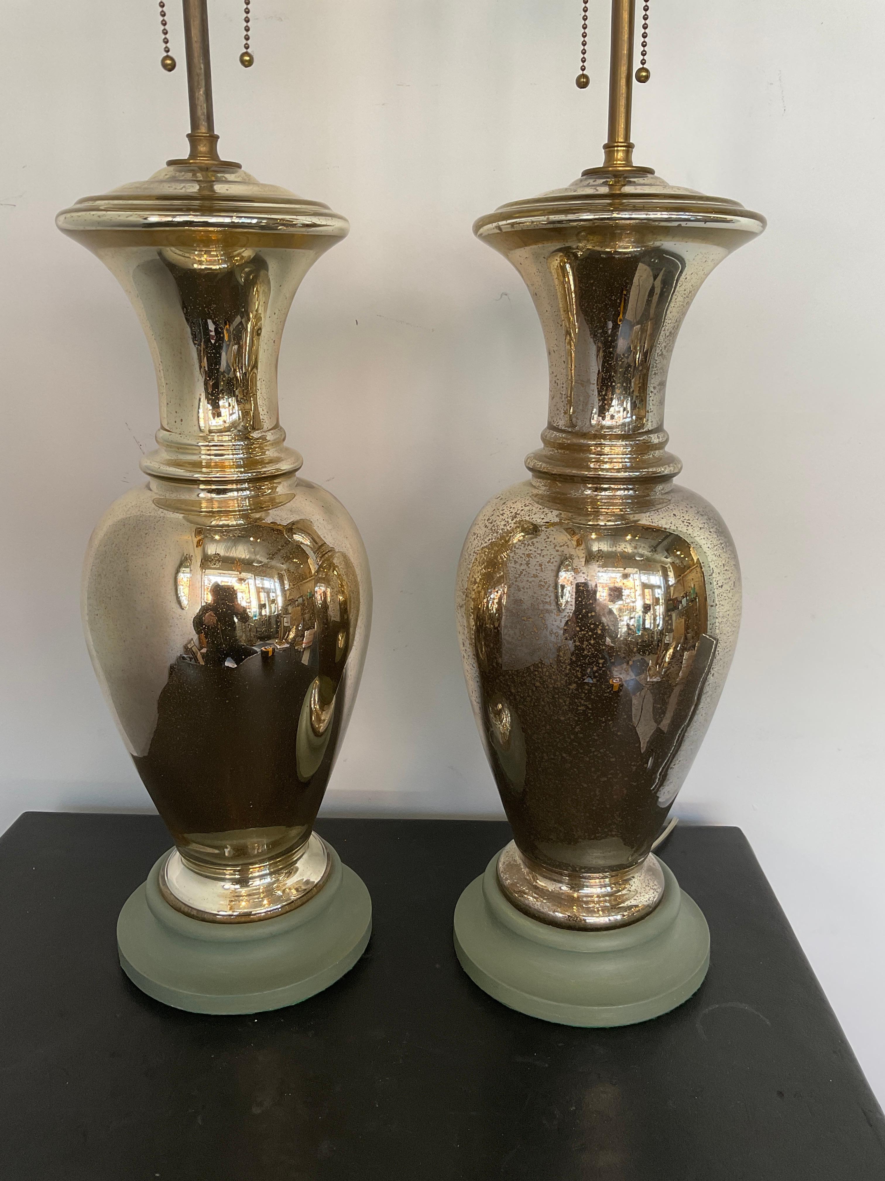 Beautiful pair of 1950s mercury glass lamps on wood bases. I love all the dark spots on the glass . In picture 12, you see a shot of where the glass blowing rod was removed when the lamp was being blown. It’s not a chip, it’s not damaged, it’s