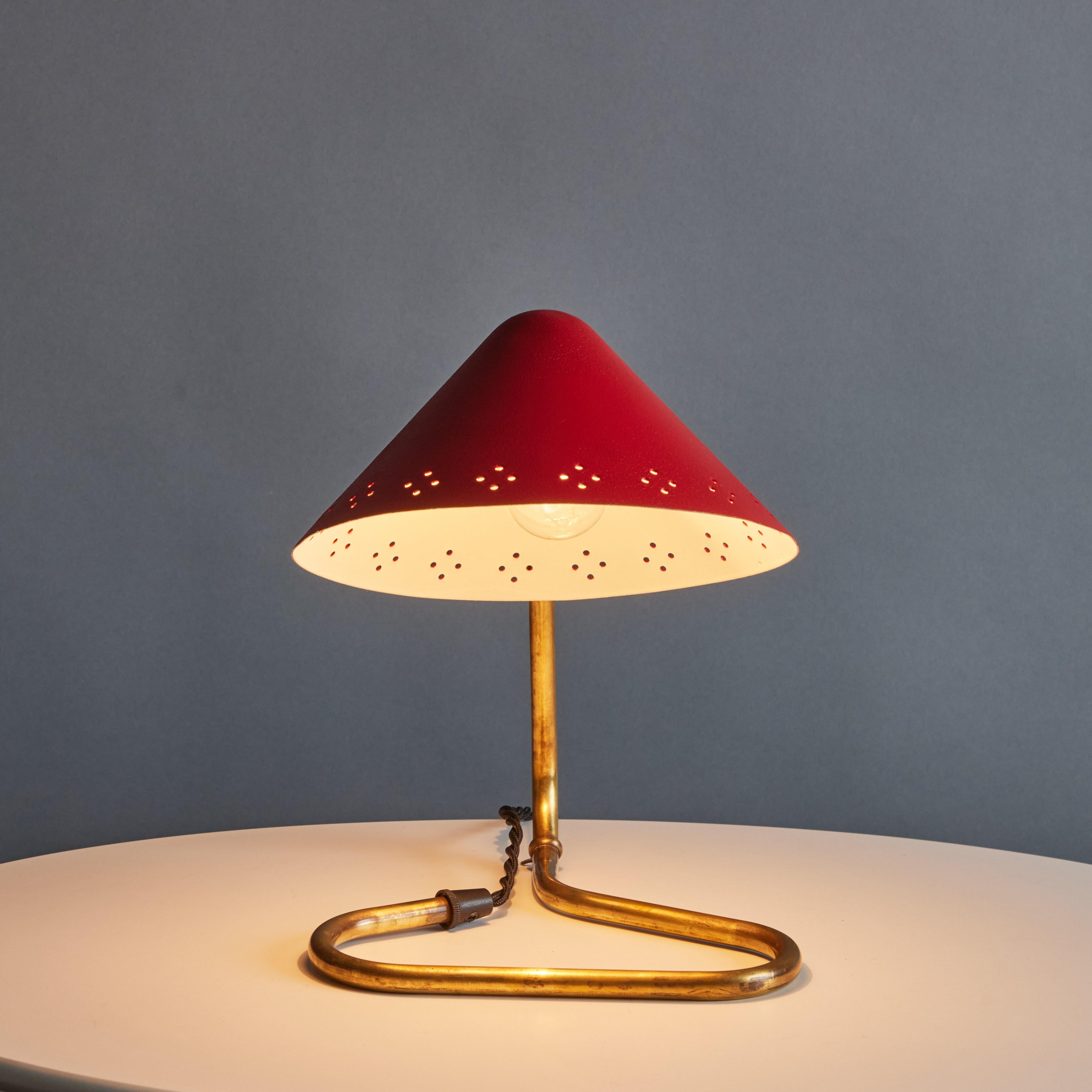 Pair of 1950s Erik Warna 'GK14' Red and Brass Perforated Shade Table Lamps. Executed in perforated red painted metal and patinated brass. Shade is adjustable and can be rotate up or down. Produced by Gnosjö Konstsmide Rydahls in Sweden in the