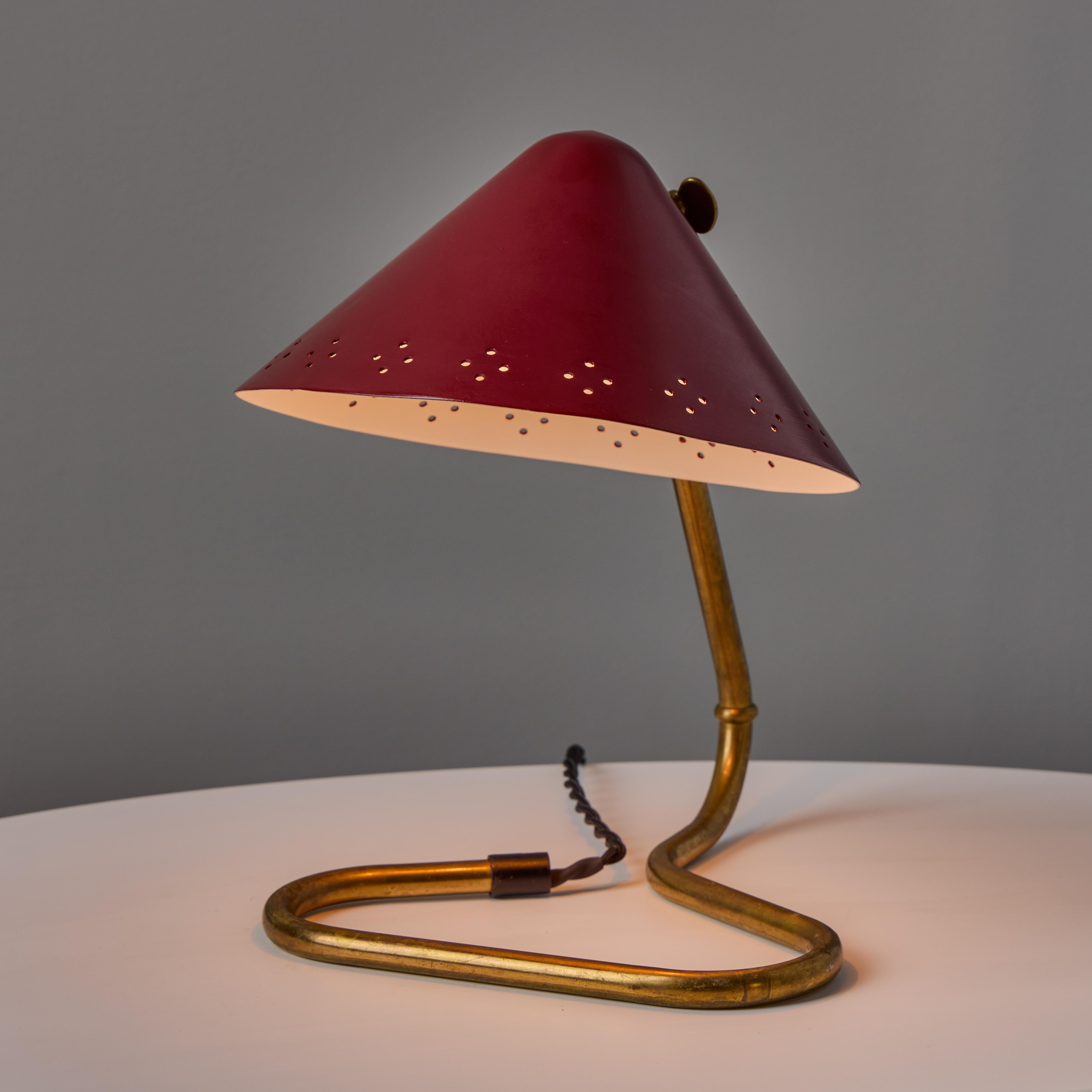 Pair of 1950s Erik Warna 'GK14' Red Perforated Shade Table Lamps. Executed in perforated red painted metal and patinated brass. Shade is adjustable and can be rotate up or down. Produced by Gnosjö Konstsmide Rydahls in Sweden in the mid-century. A