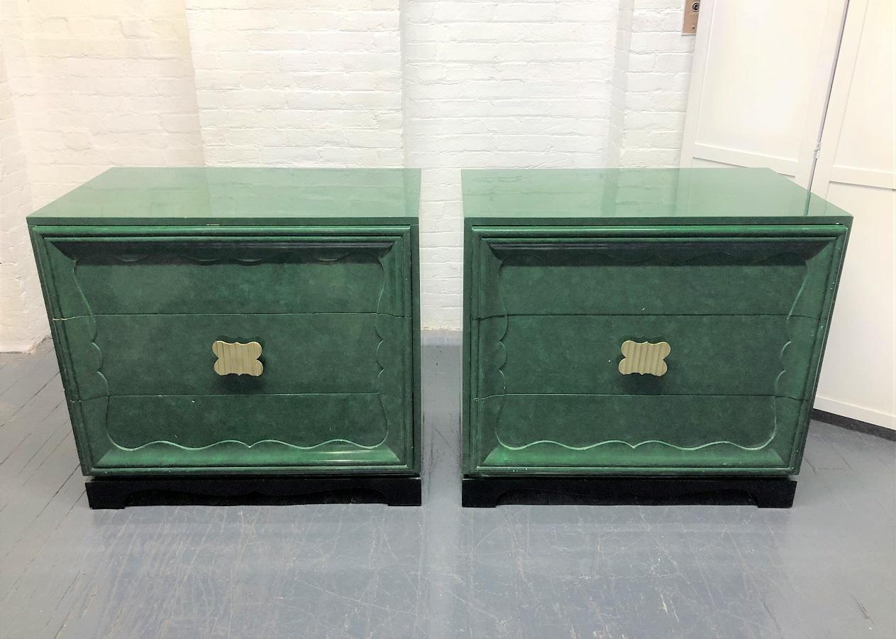 Pair of 1950s faux green Malachite chests in the style of James Mont. Each chest is wood with a green painted finish, a black lacquered base, three pull out drawers with a bronze decorative handles. Style of James Mont.