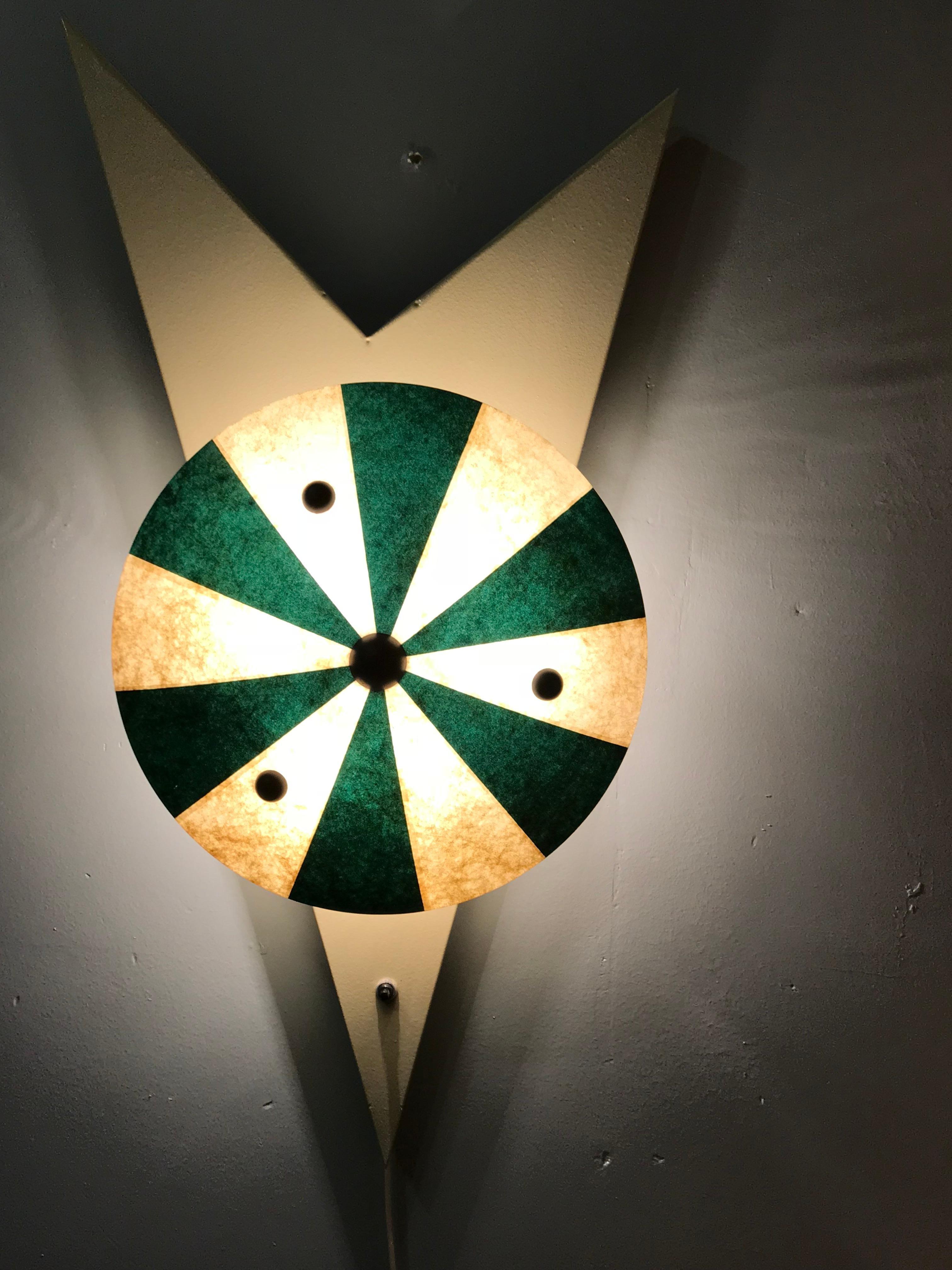 A pair of unusual sconces featuring an off-white painted metal base with white and green reflectors made of fiberglass.
 