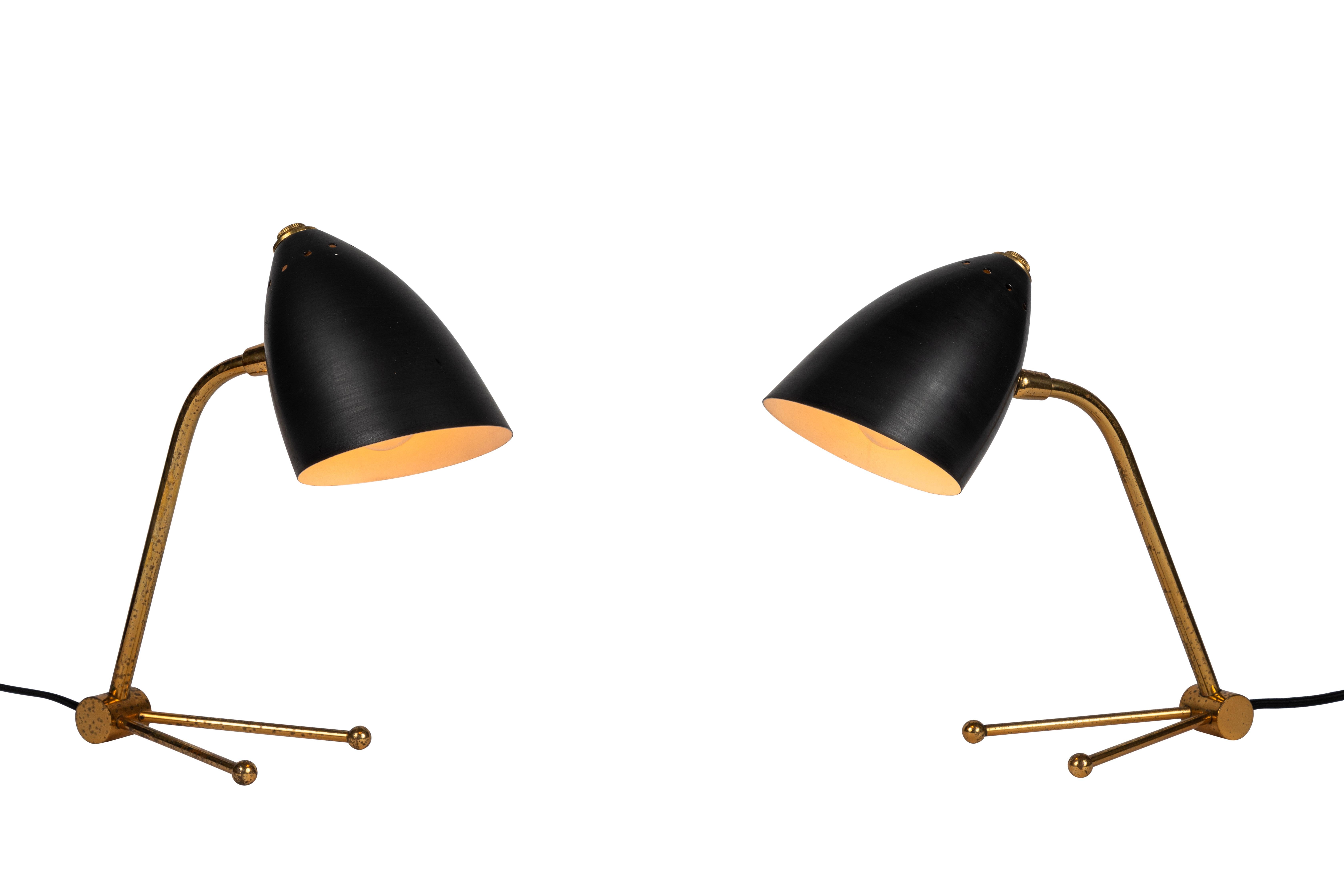 Pair of 1950s Finnish table lamps attributed to Mauri Almari. Executed in black painted metal and patinated brass. Shades rotate up and down and side to side. An incredibly refined design that is quintessentially Finnish.

A contemporary of Paavo
