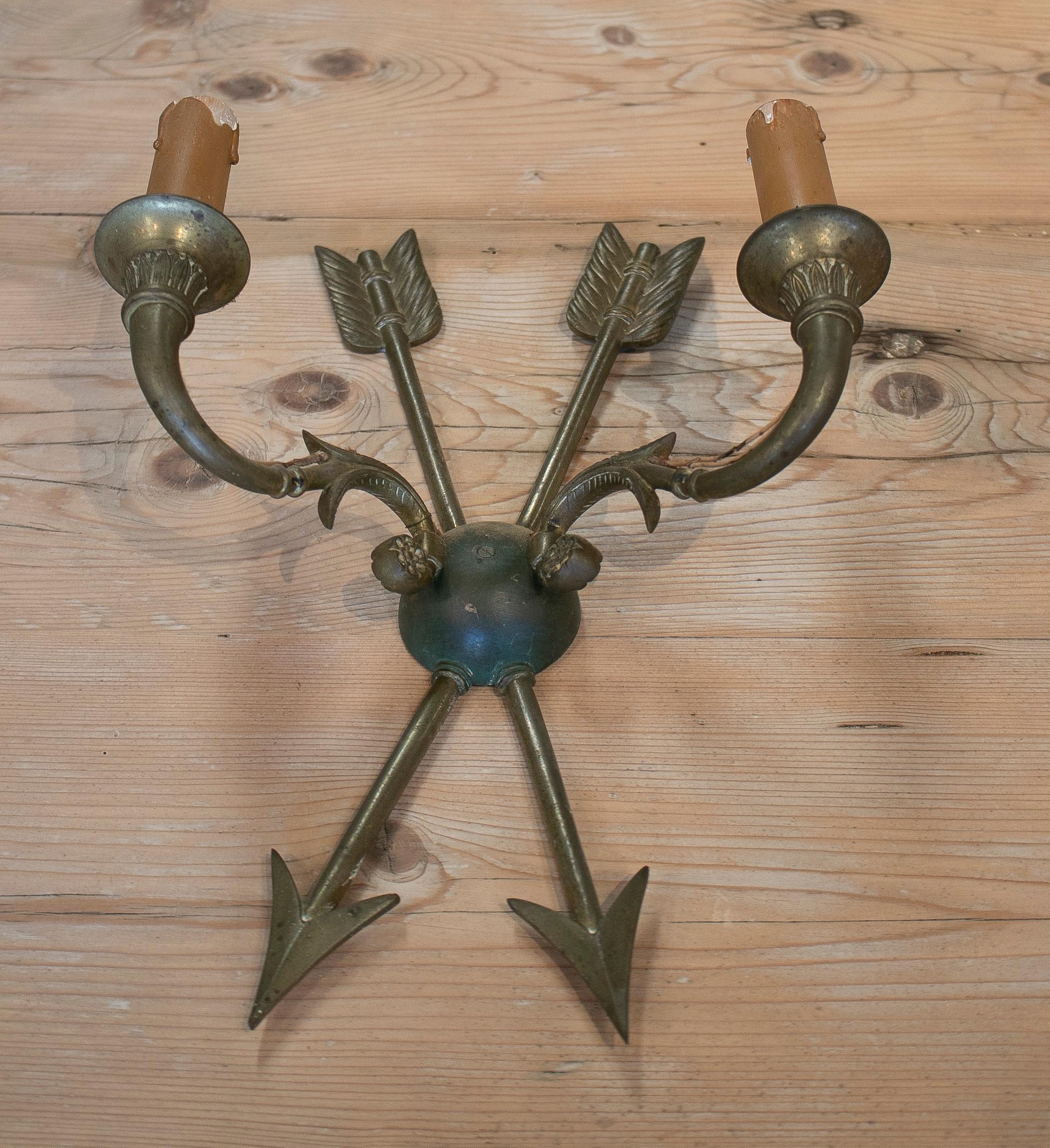 Vintage pair of 1950s French bronze 2-arm wall sconces with crossed arrows.