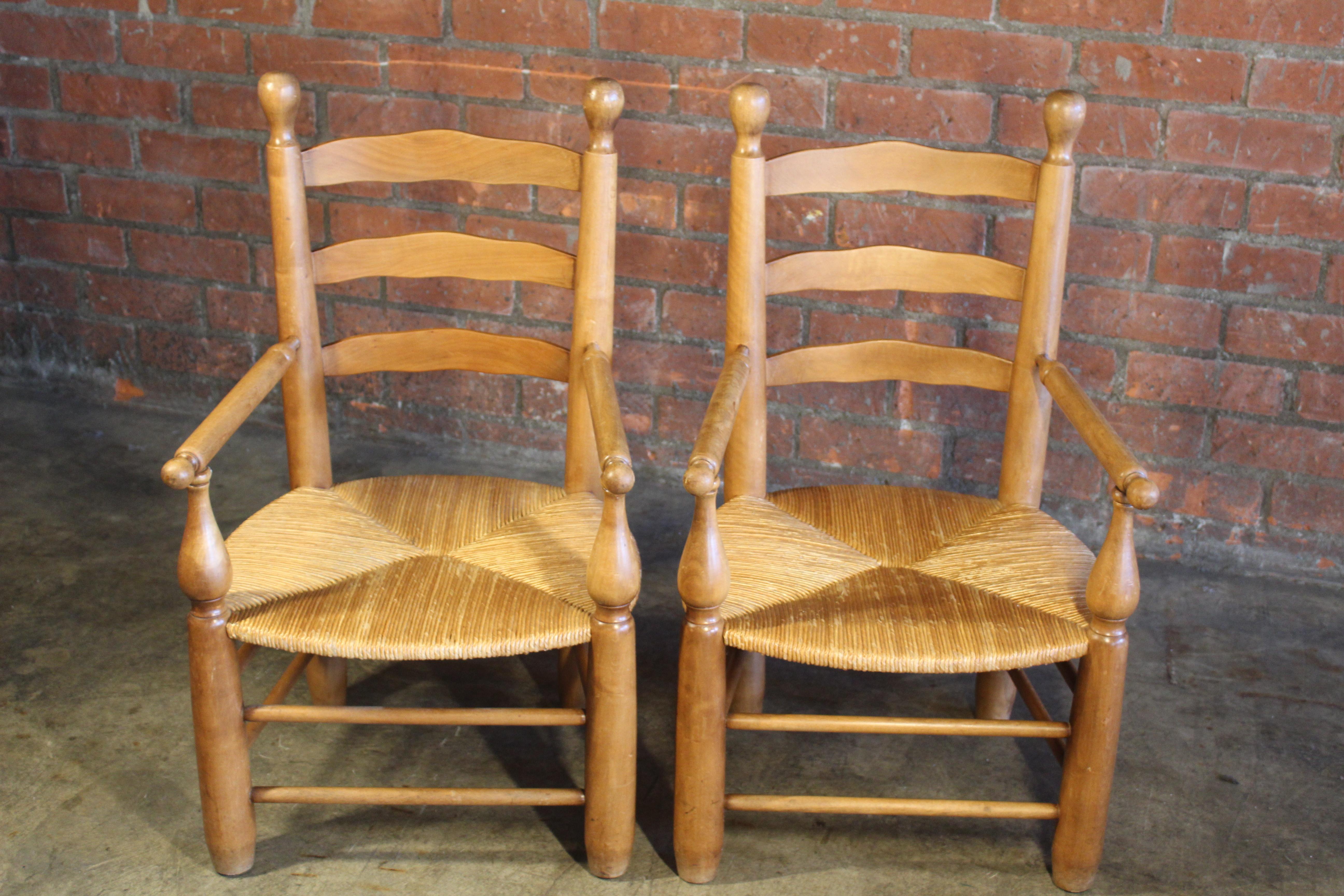 Pair of vintage 1950s French country armchairs with rush seats.