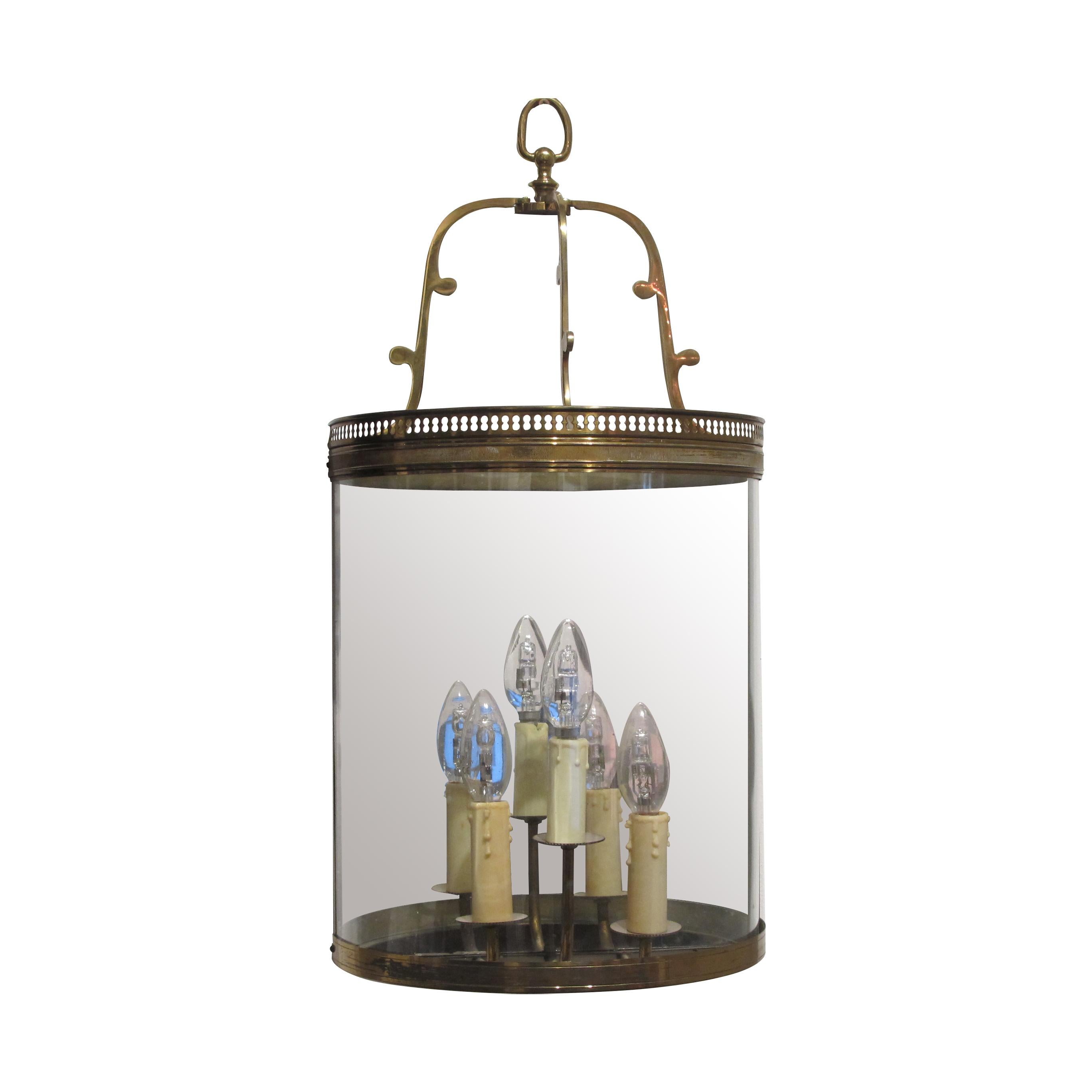 A Classic pair of 1950s French demilune wall lanterns with a single curved pane of glass which is supported on a decorative brass frame. Each lantern has three arms and a mirrored back plate which allows the light to reflect outwards. 

Recently