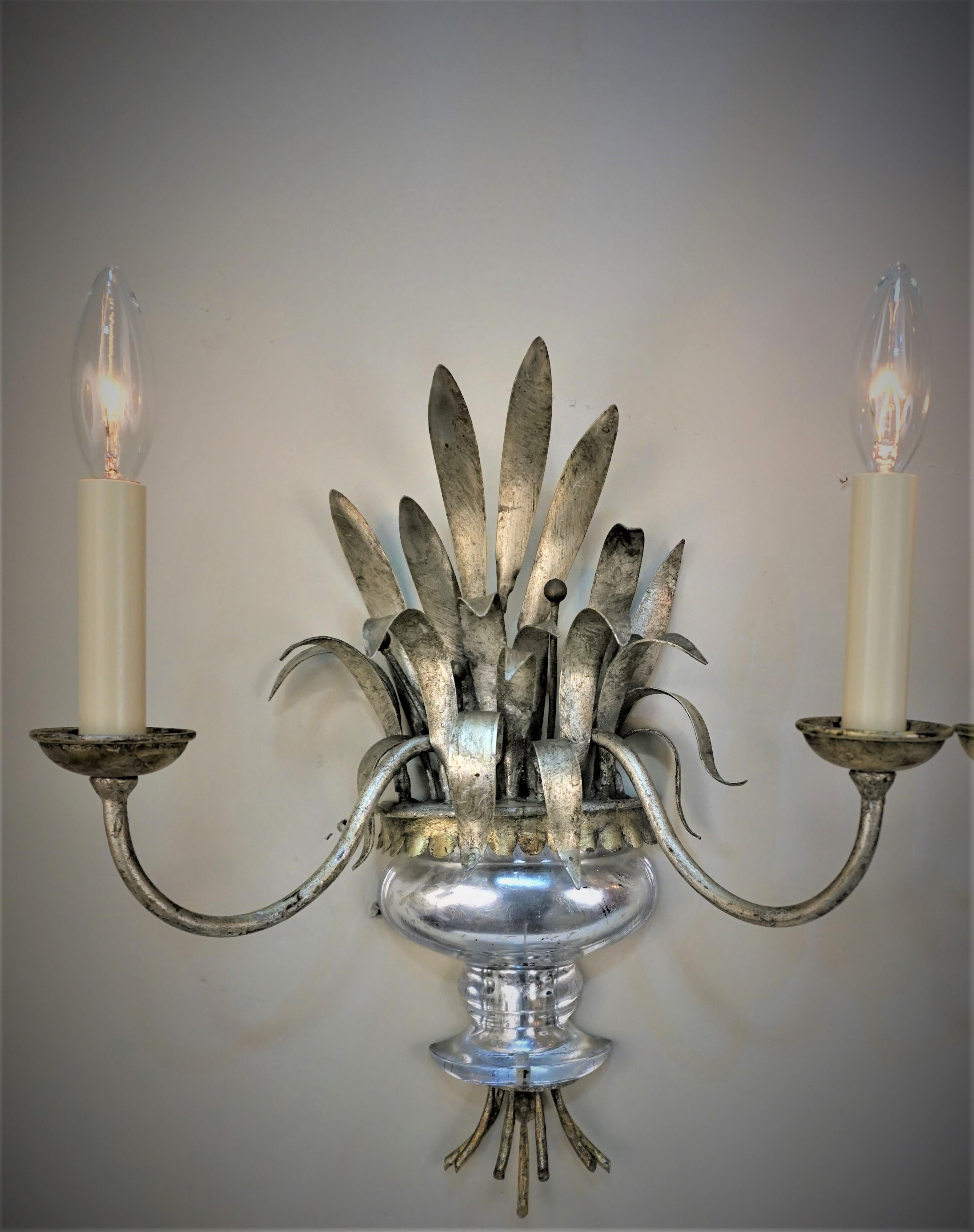 Pair of double arm gold and silver leaf Maison Bagues wall sconces
New wiring.