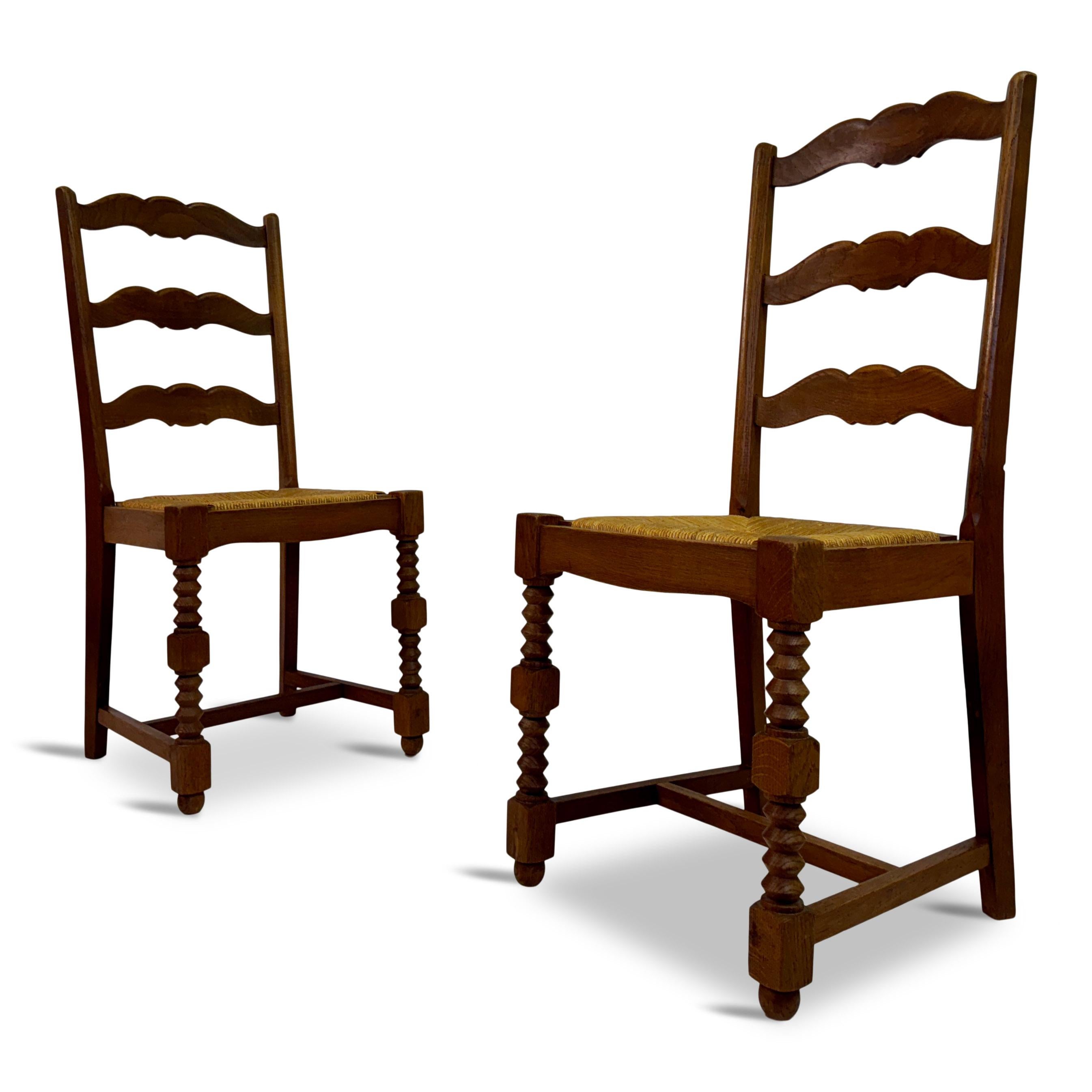 Pair of side chairs

Oak and rush

Seat height 47cm

In the style of Charles Dudouyt

France 1950s

A pair of French side chairs with a classic and rustic design, characteristic of traditional French country furniture. These chairs feature a