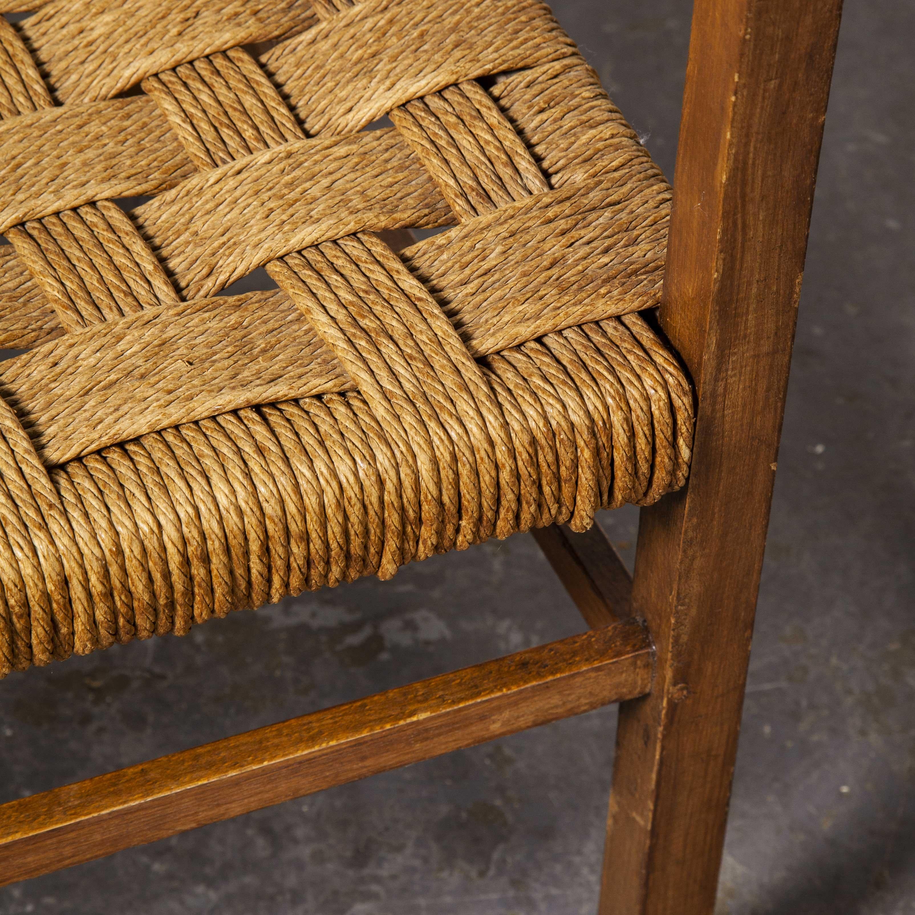 Pair of 1950s French woven rush seated armchairs

Pair of 1950s French woven rush seated armchairs. An elegant pair of oak framed arm chairs with refined slatted backs and sculptural arms. The seats retain their original handwoven seagrass which has