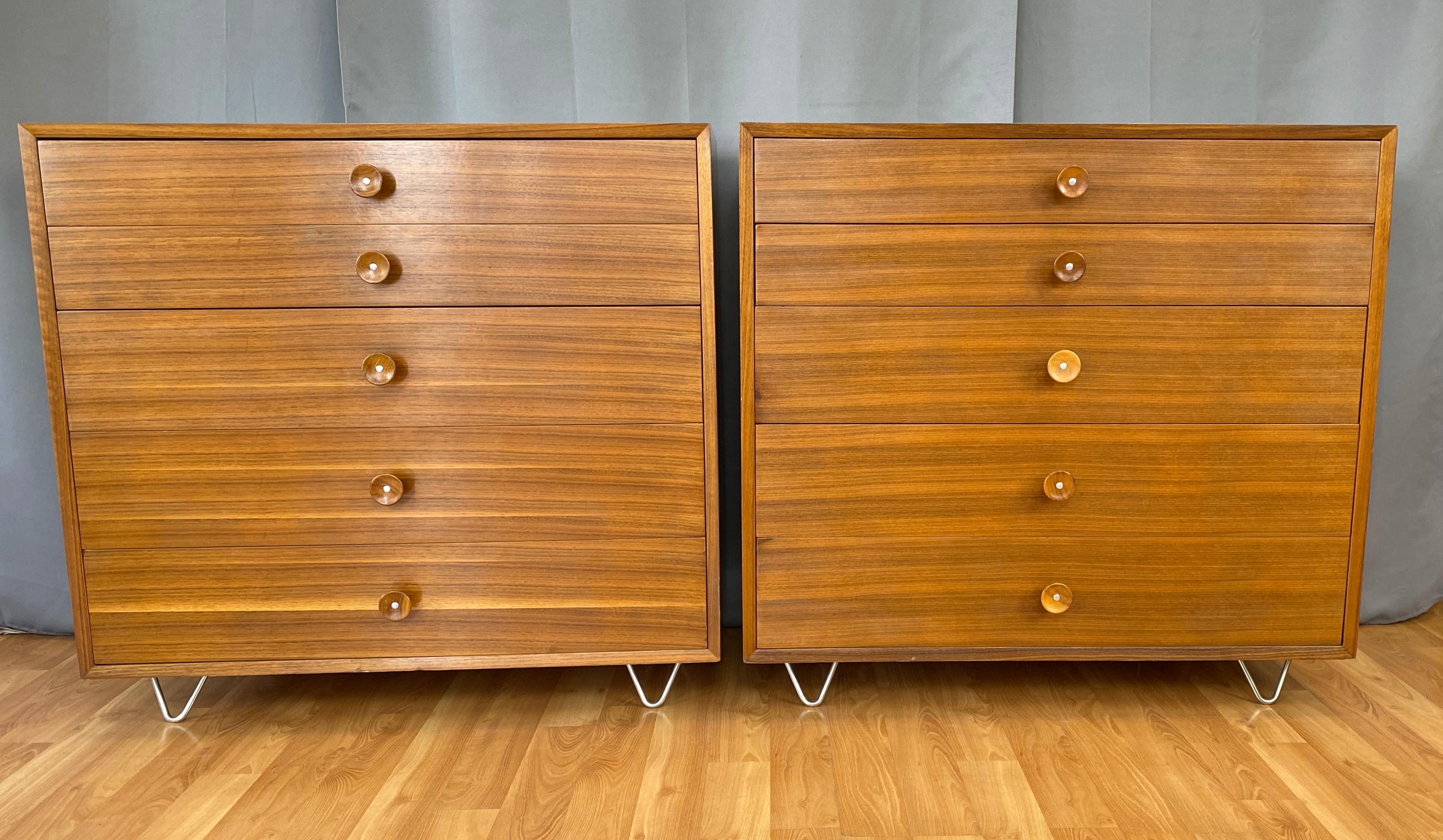 A pair of George Nelson designed dressers for Herman Miller. Both dressers are Walnut and have cupcake pulls.
Five drawers on each, with the top drawer on both has dividers. Labels in top drawers, right side.
Both have newer hairpin legs.