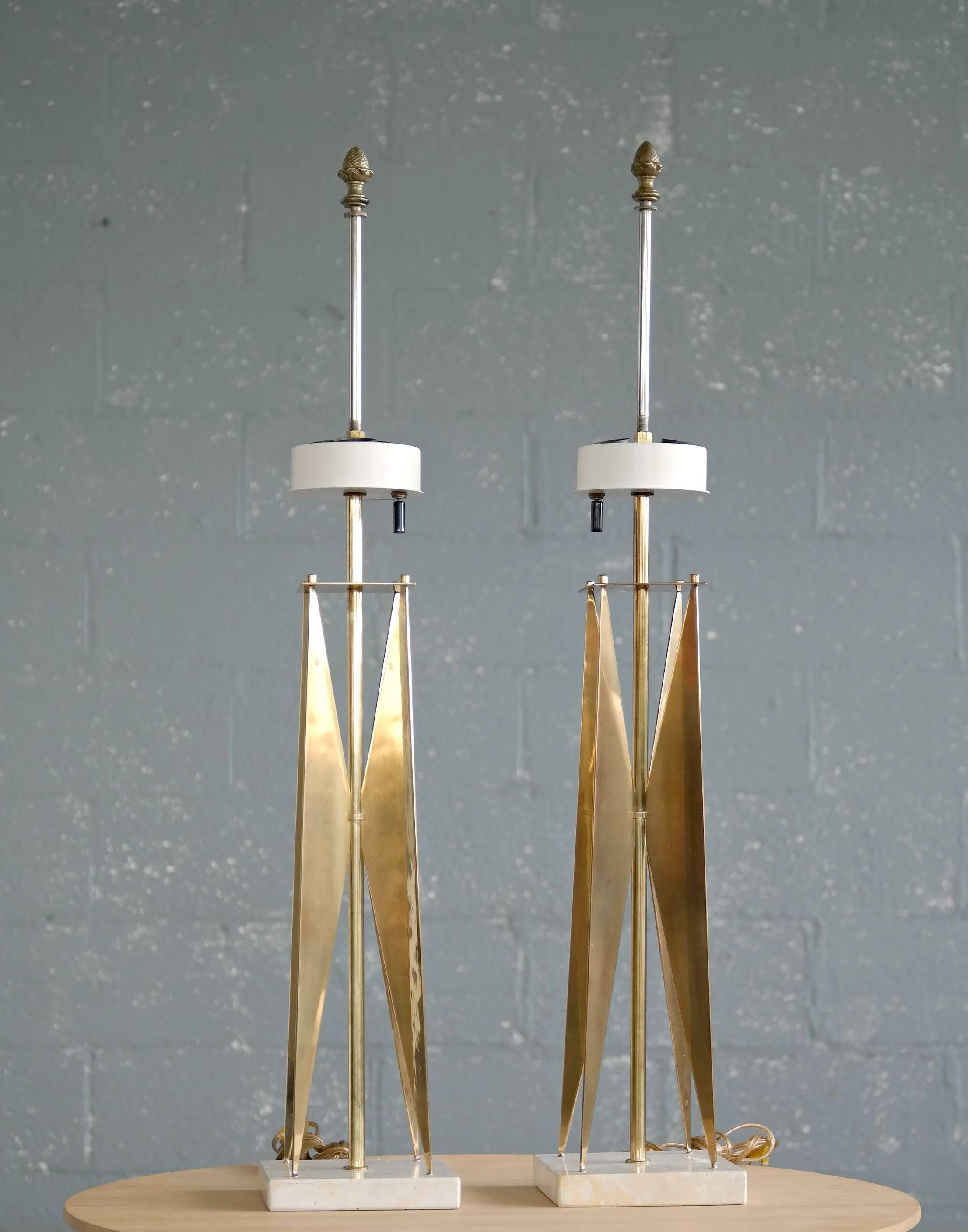 A rare pair of sculptural table lamps in hand polished brass and travertine designed by Gerald Thurston for Lightolier in the 1950s. Probably some of the most elegant and impressive lamps to come out of the era and Thurston underscoring why