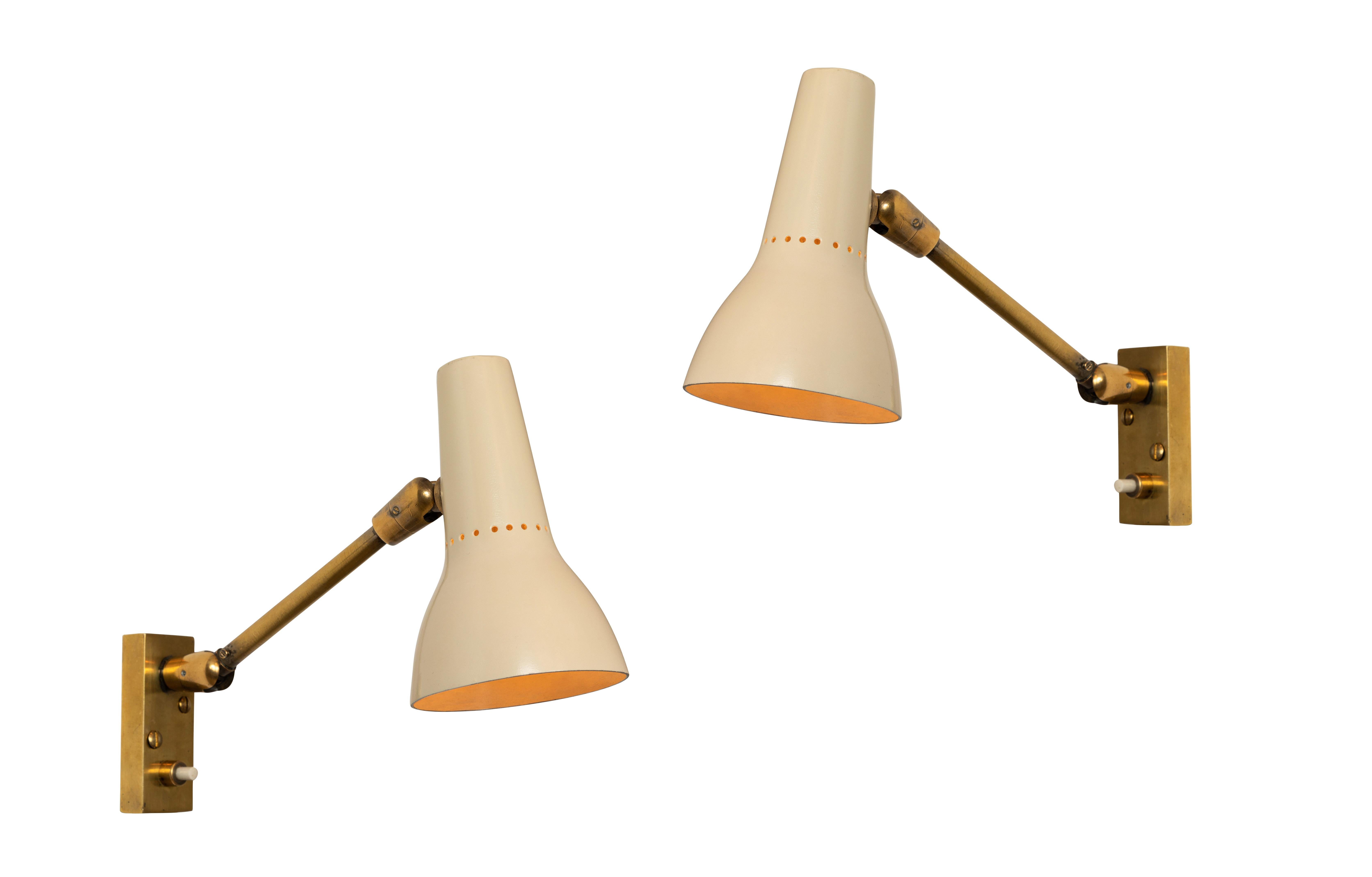 Pair of 1950s Giuseppe Ostuni Wall Lamps for O-Luce. An extremely rare matched pair executed in brass and enameled metal by one of the most refined Italian designers of the midcentury. A highly adjustable wall light, the arms can be rotated