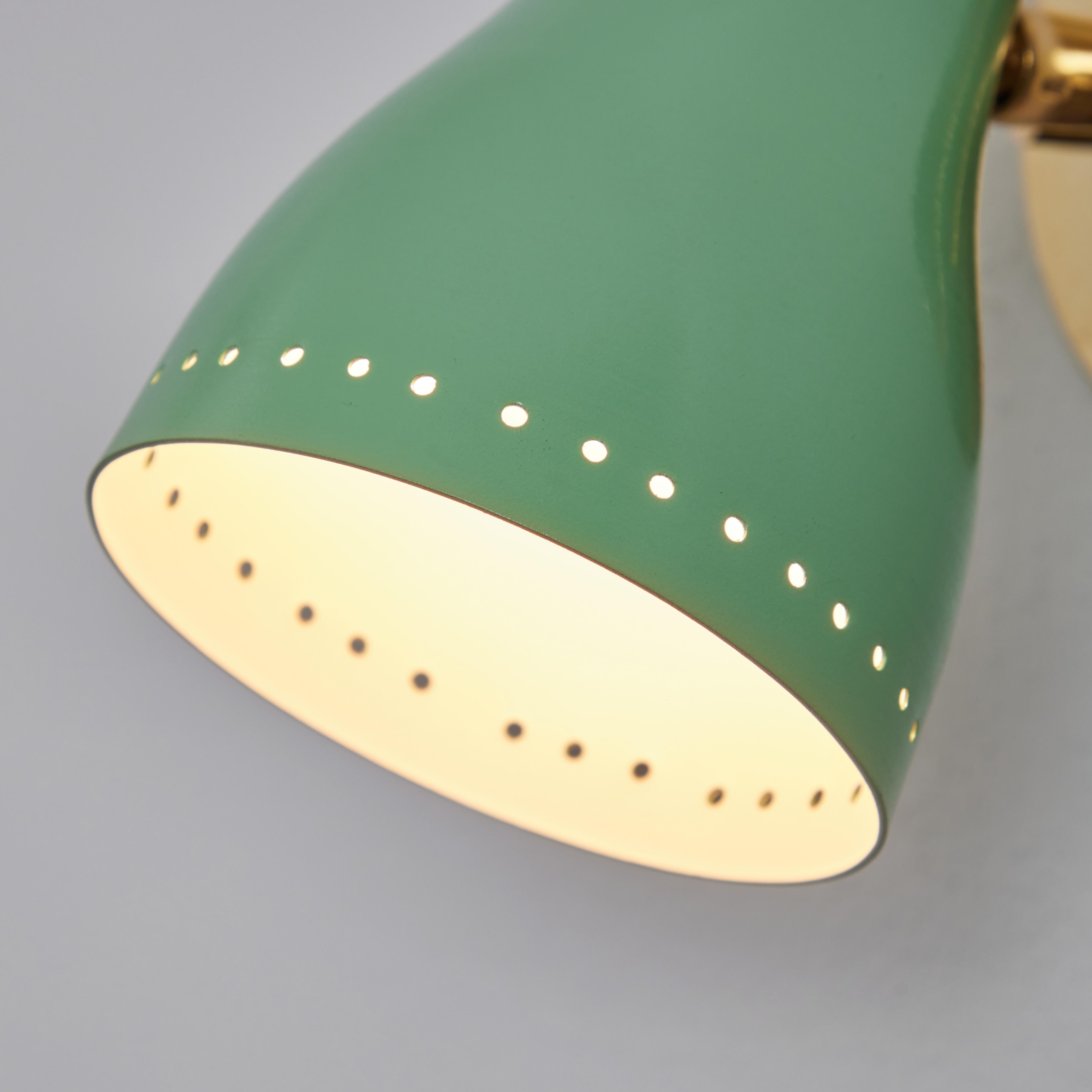Pair of 1950s green perforated sconces attributed to Jacques Biny. A exceptionally clean and simple design executed in brass with green painted perforated metal shade with on/off switch at top. Lamps rotate freely on adjustable swivel.