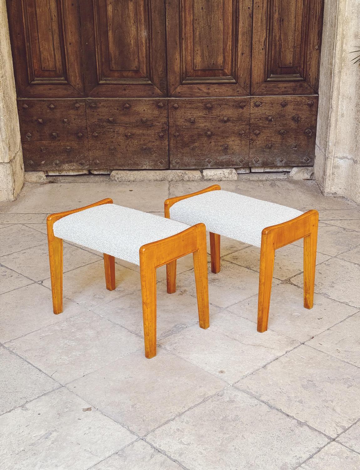 A beautiful pair of 1950s wooden foot stools by the Italian designer, Ico Parisi. The stools have been reupholstered in a neutral Dedar boucle fabric and the pair are in excellent condition.