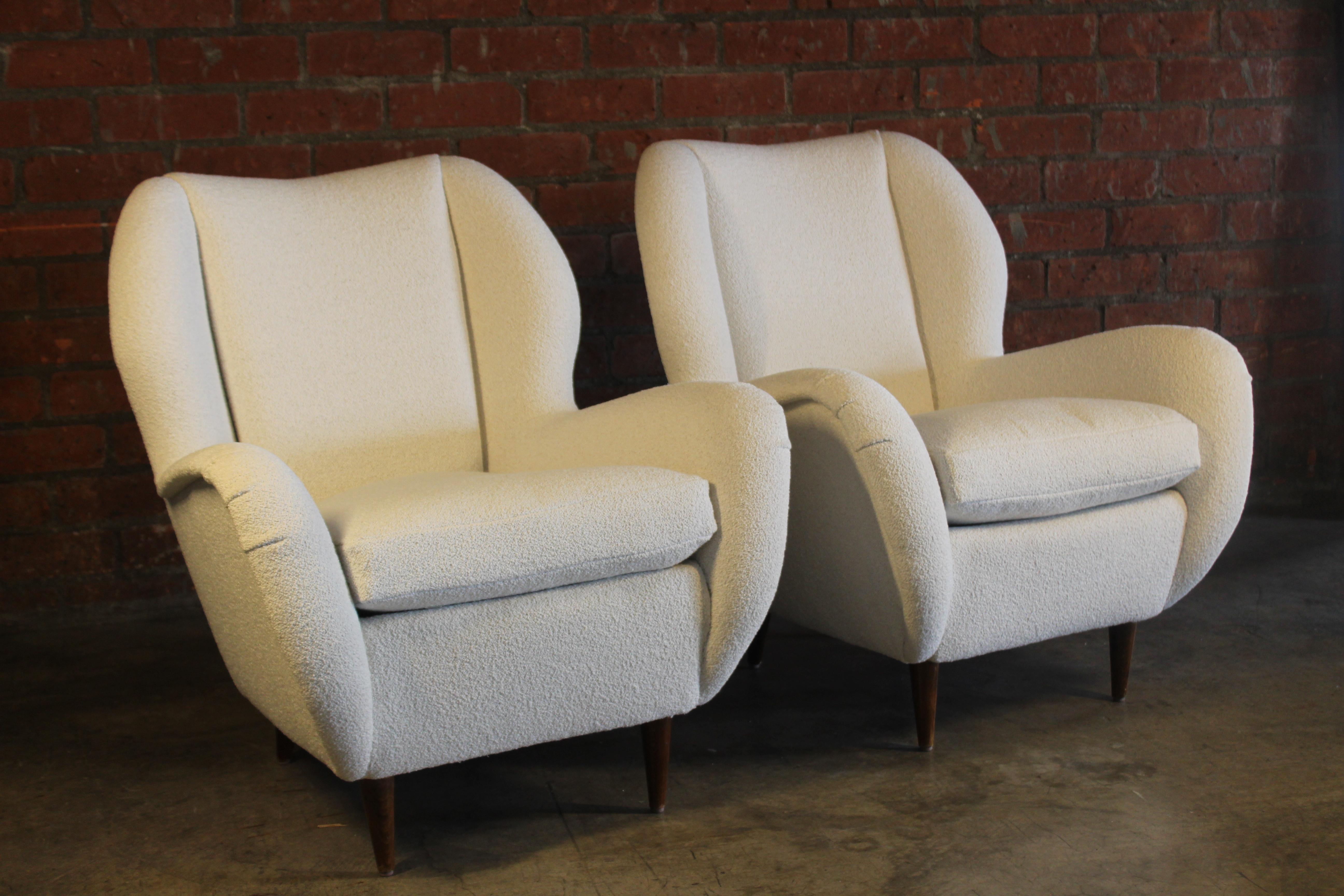 Pair of vintage 1950s Italian lounge chairs attributed to Paolo Buffa. Reupholstered in a wool blend Italian boucle. Tapered walnut legs retain their original finish. Both are in excellent condition.
