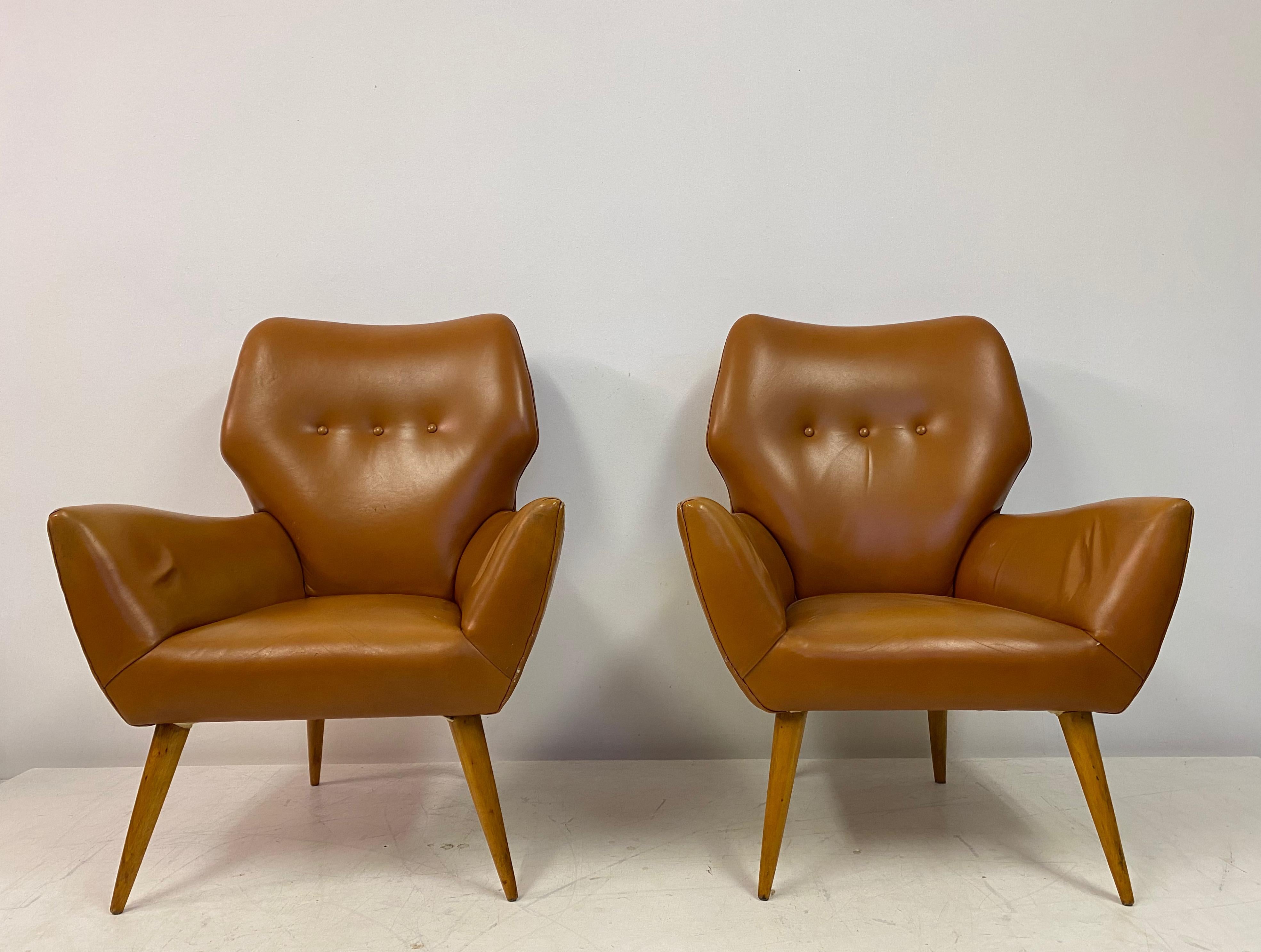 Pair of armchairs

Upholstered in leather

Turned beech legs

Seat height 38cm

Italy 1950s