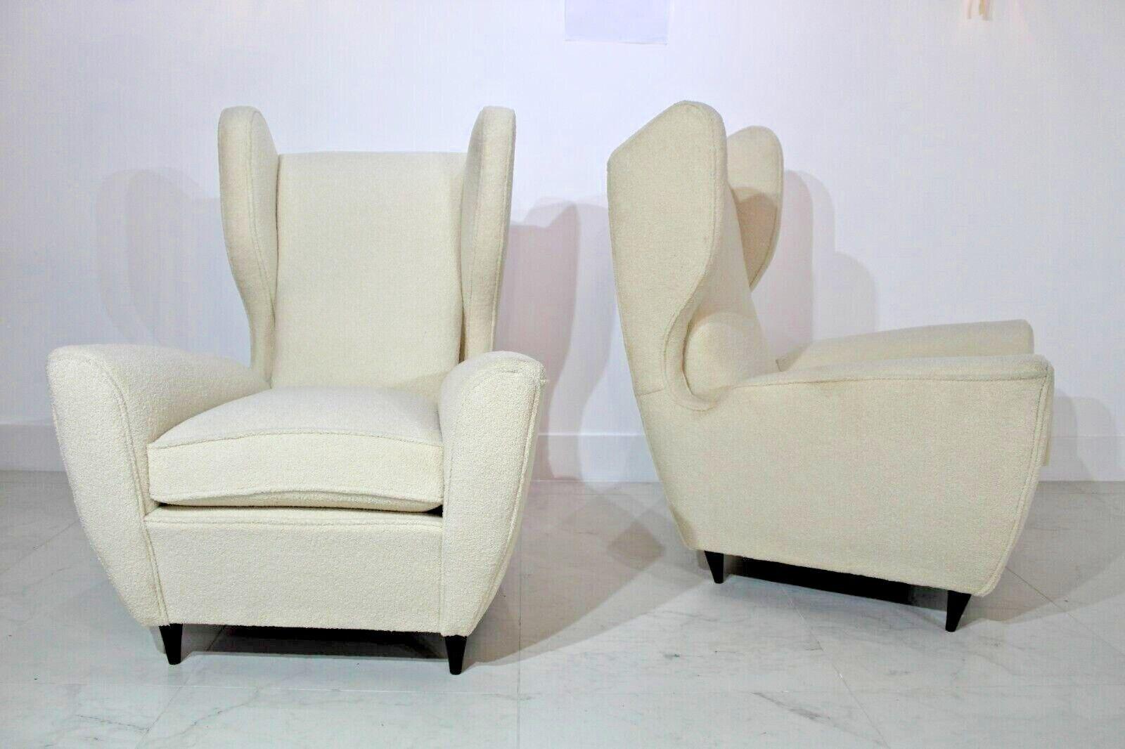 Pair of 1950's Italian armchairs recently reupholstered in cream boucle in the Manner of Gio Ponti.