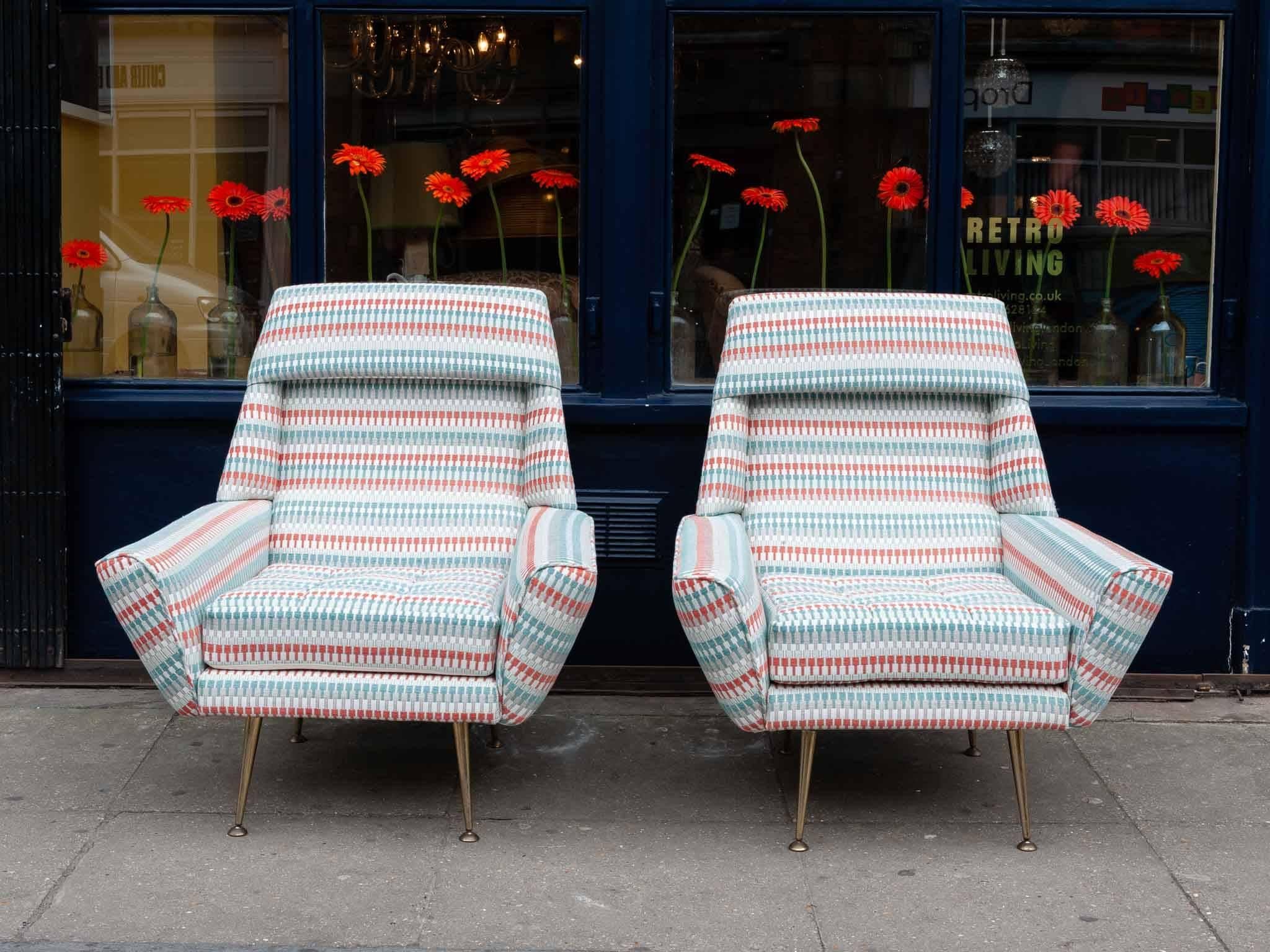 Pair of 1950s Italian armchairs beautifully reupholstered in Romo Group's Villa Nova Shiko Eden fabric. The chairs sit on four vintage brass screw in legs. Incredibly comfortable with a wide seat and padded headrest. Perfect to add some vibrancy and