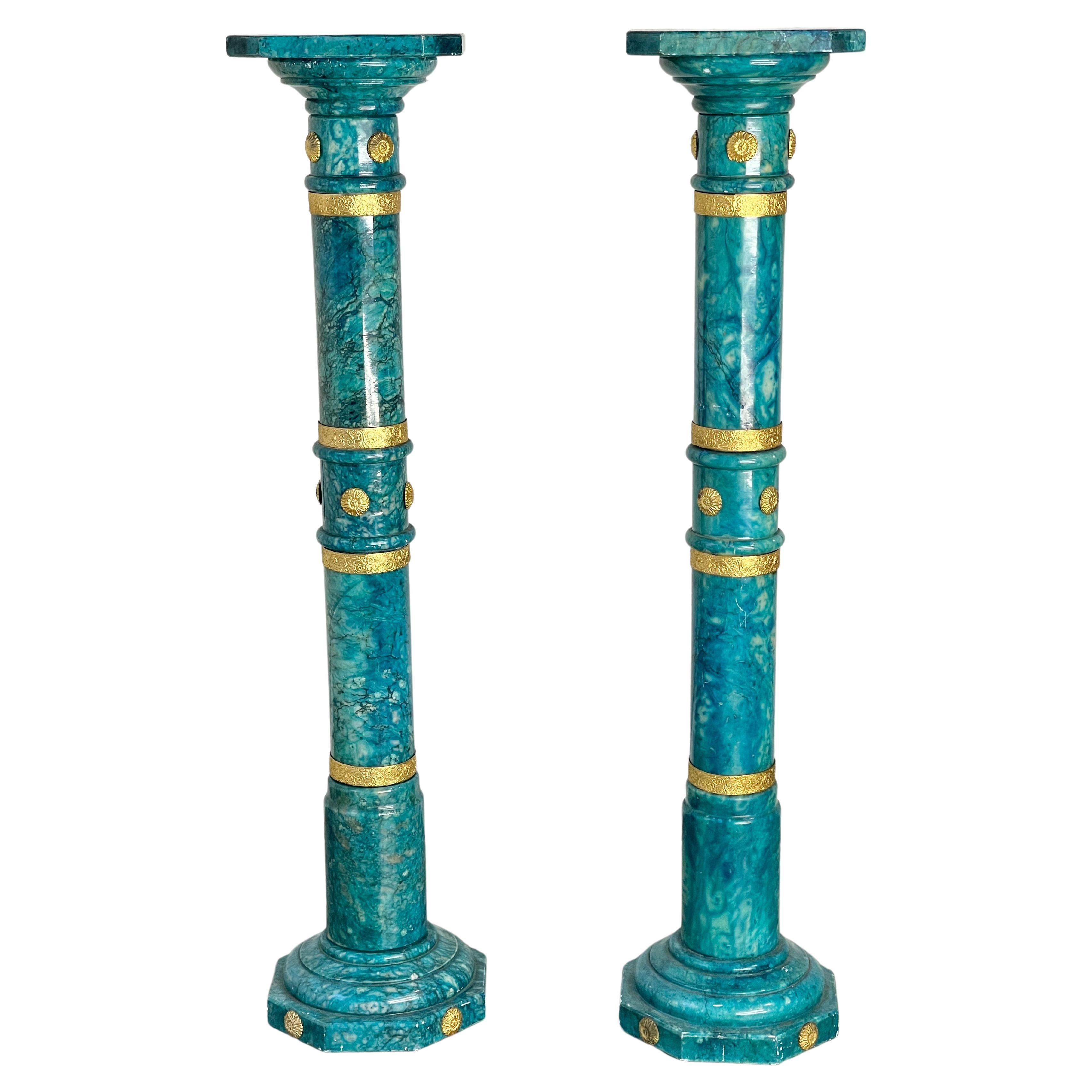 Pair of vintage Italian alabaster pedestal columns in vibrant blue-green color (not quite turquoise) and embellished with gilt brass bands and button medallions.
Their extraordinary color appears to have been achieved with a penetrating transparent