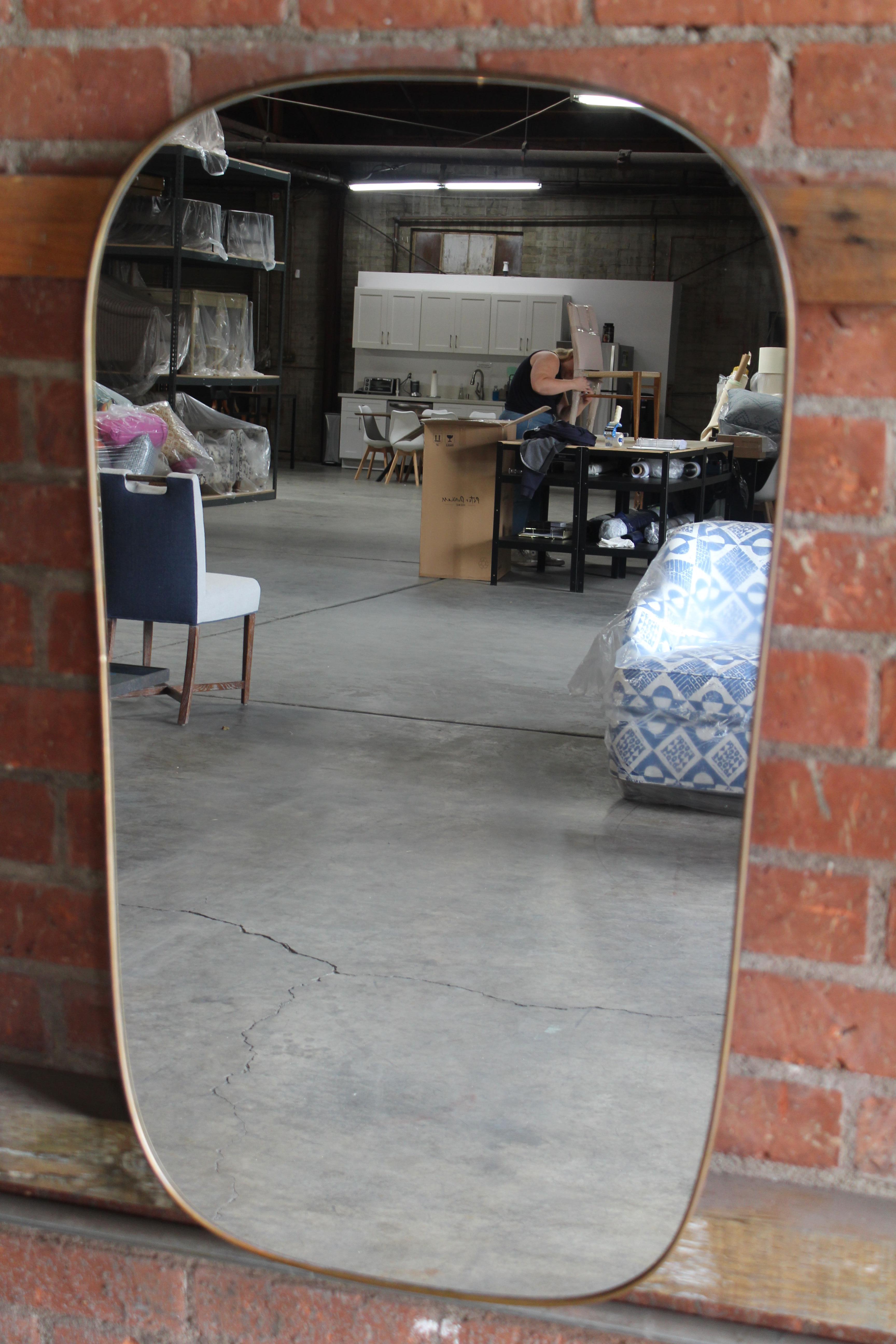 Pair of 1950s Italian brass framed wall mirrors. Matching- sold as a pair. In wonderful original condition with patina to the brass frames. French cleats have been recently added.