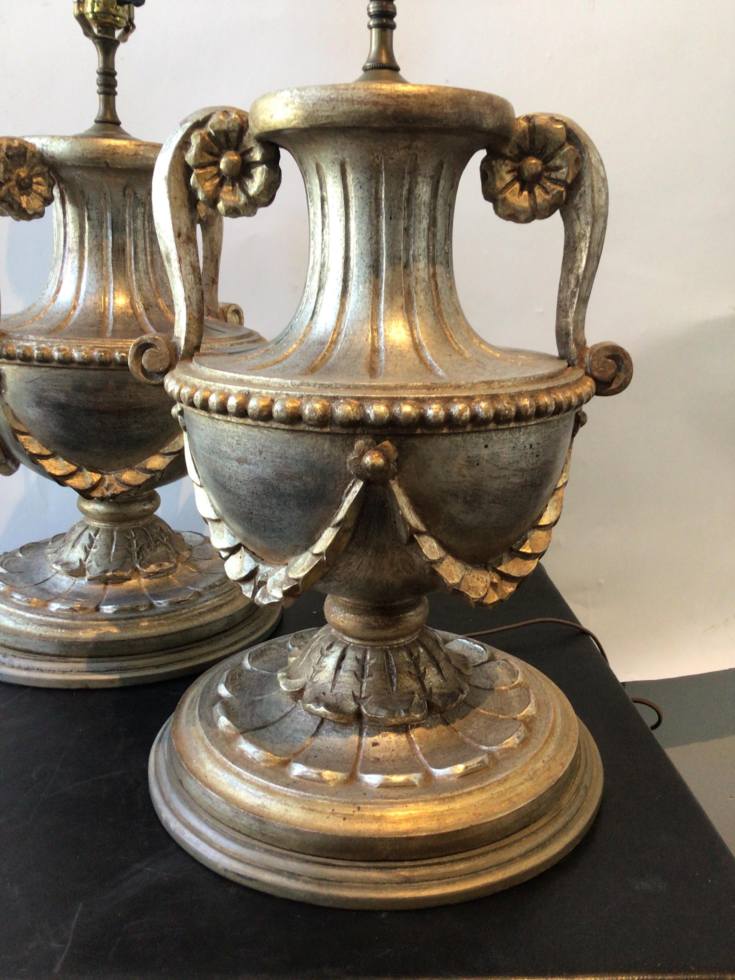 Pair of large 1950s Italian hand carved wood silver leaf urn lamps. Wood finial. From a very famous media moguls Hamptons estate.