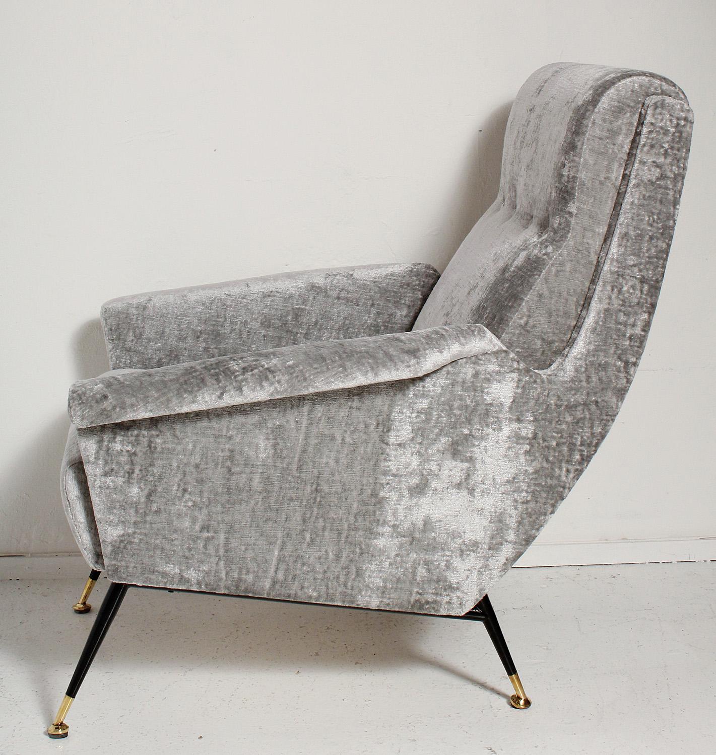 Sexy pair of fully restored 1950s Italian lounge chairs have black metal legs with solid brass sabots, and are upholstered in a luxe, richly textured, grey velvet.