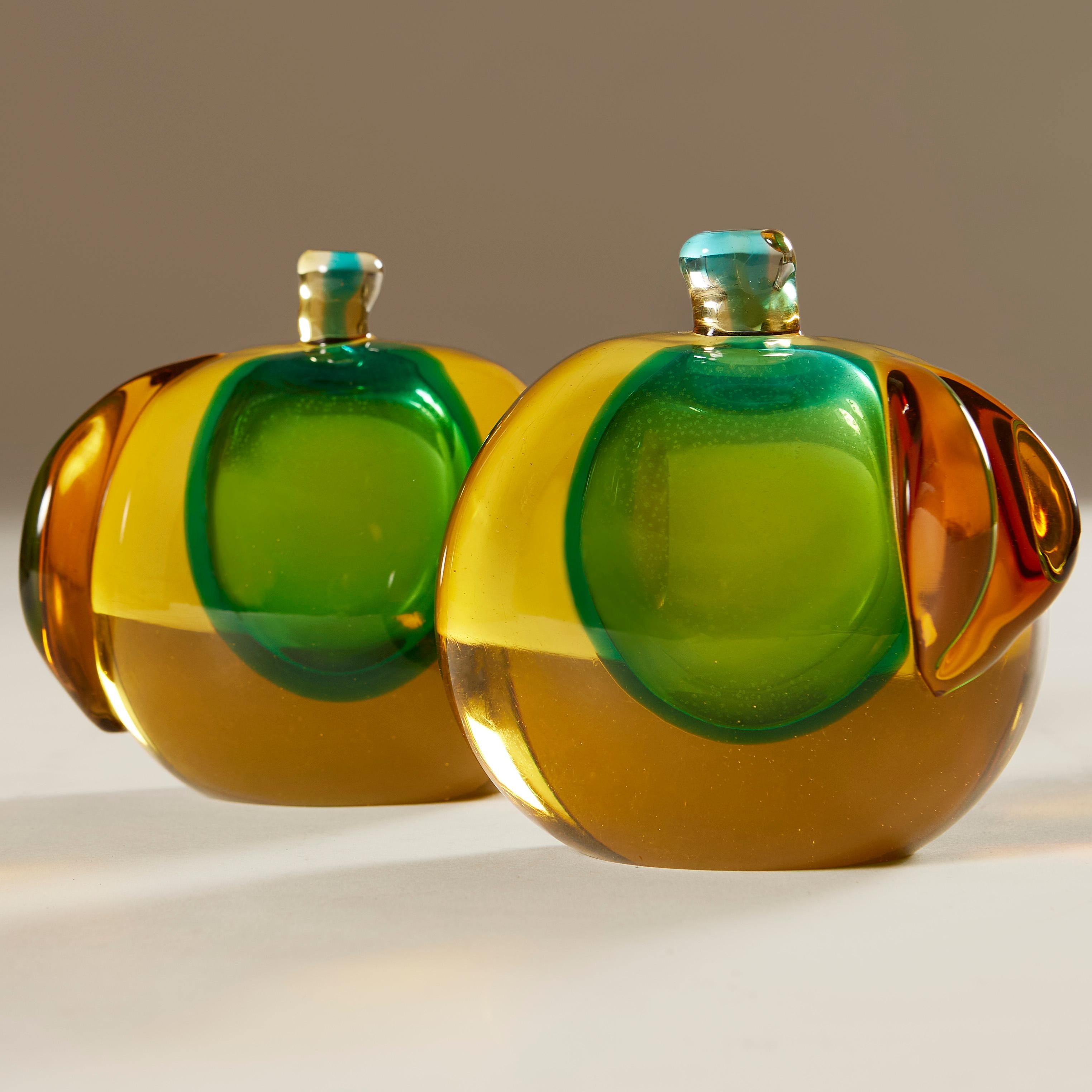 Handblown super smooth rich green, bronze and deep gold Murano glass bookends designed by Salviati. Each with a flat side to become bookends if required and a sculpted single bronze leaf to create the apple shape. Works equally well as a stunning