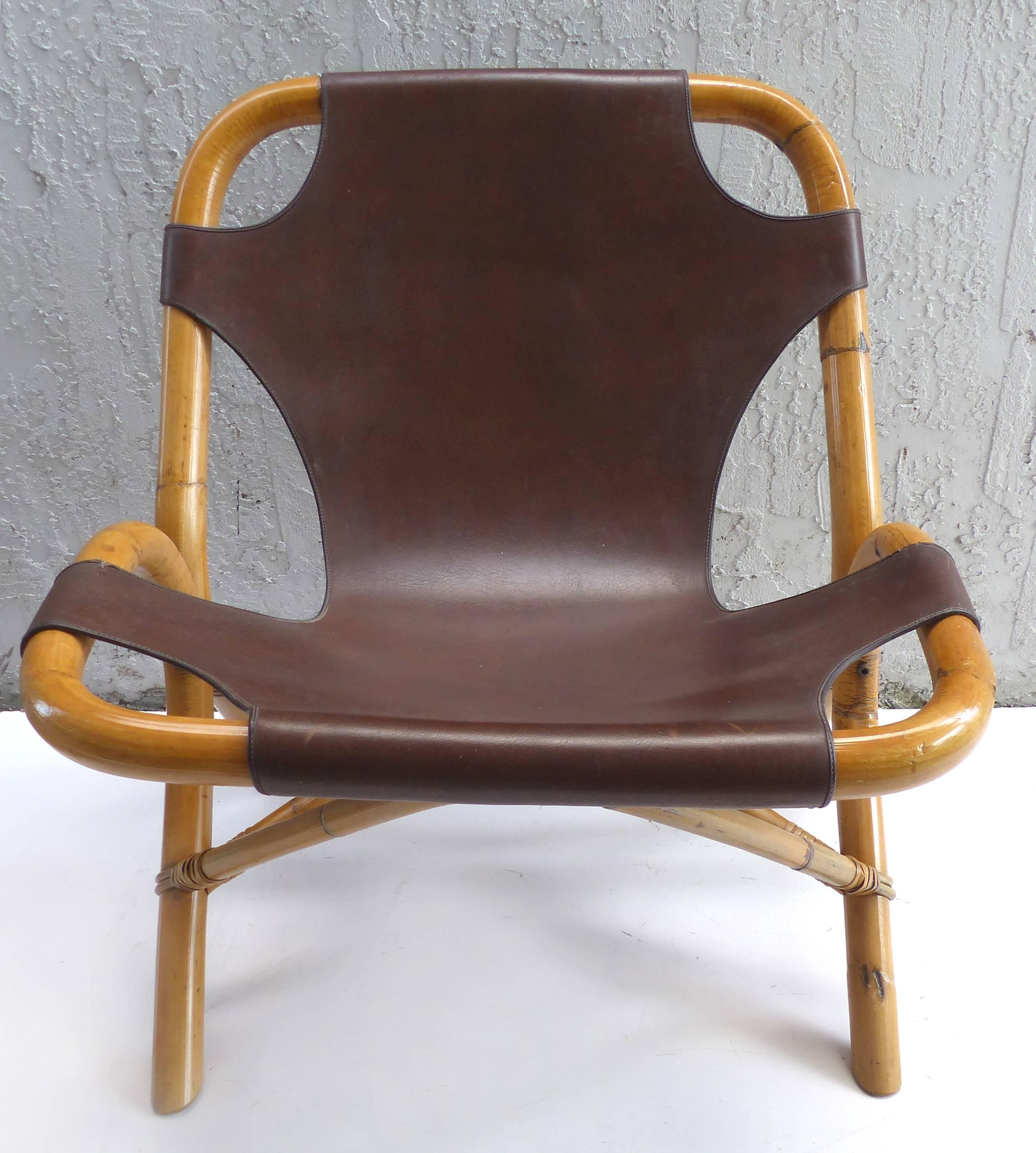 Offered for sale is a pair of Italian 1950s rattan and leather chairs by Pierantonio Bonacina. The chairs are in fine examples of Italian modern design and are in very nice condition. The have leather seats with brass studs which sling across
