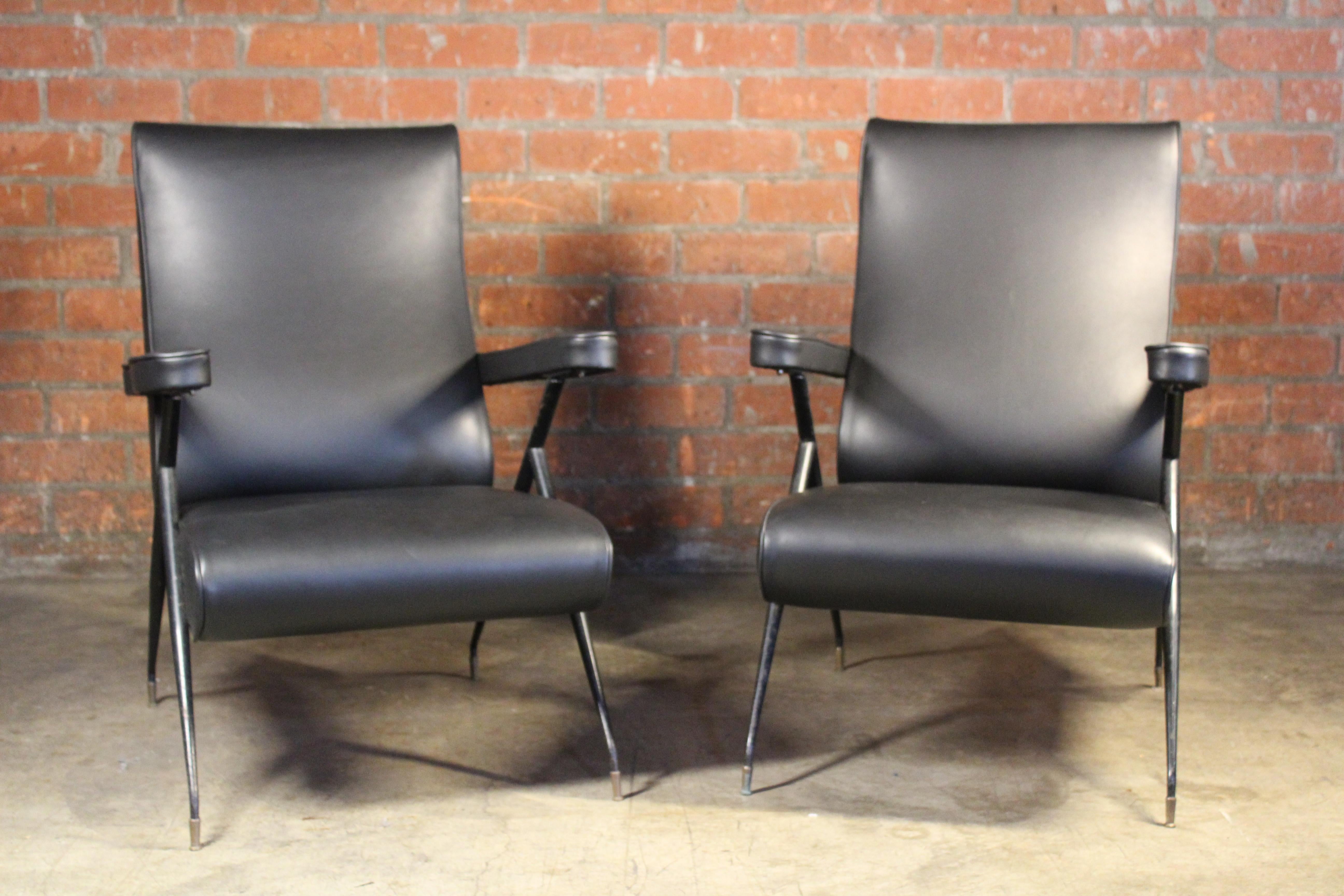 Pair of reclining armchairs, newly upholstered in black leather hide. Can be used in two positions. In good condition with patina to the metal frame. Brass sabot feet. Sold as a pair.