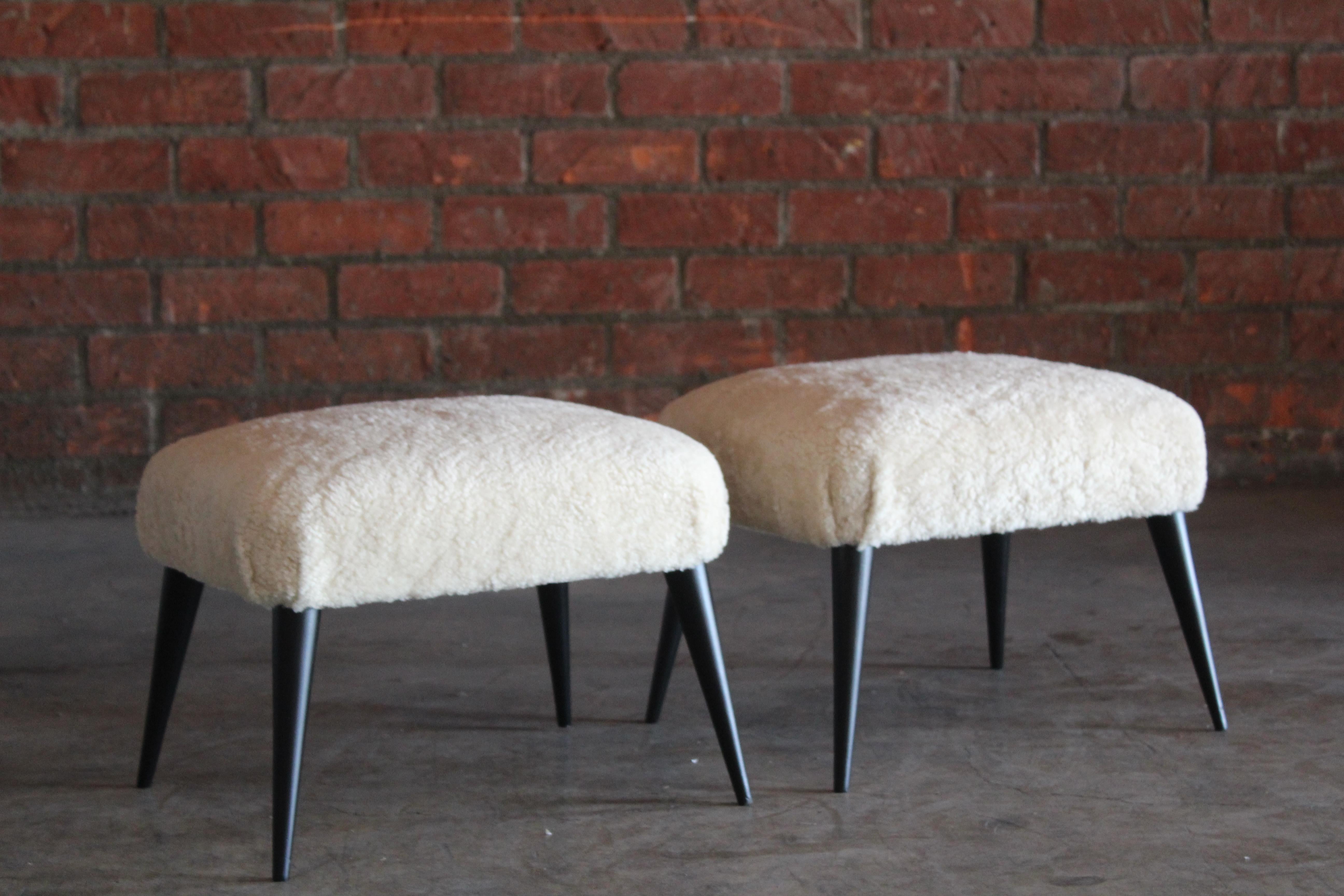 Pair of 1950s Italian stools, completely restored and reupholstered in sheepskin. The walnut legs have been refinished satin black. In overall excellent condition. Sold as a pair.