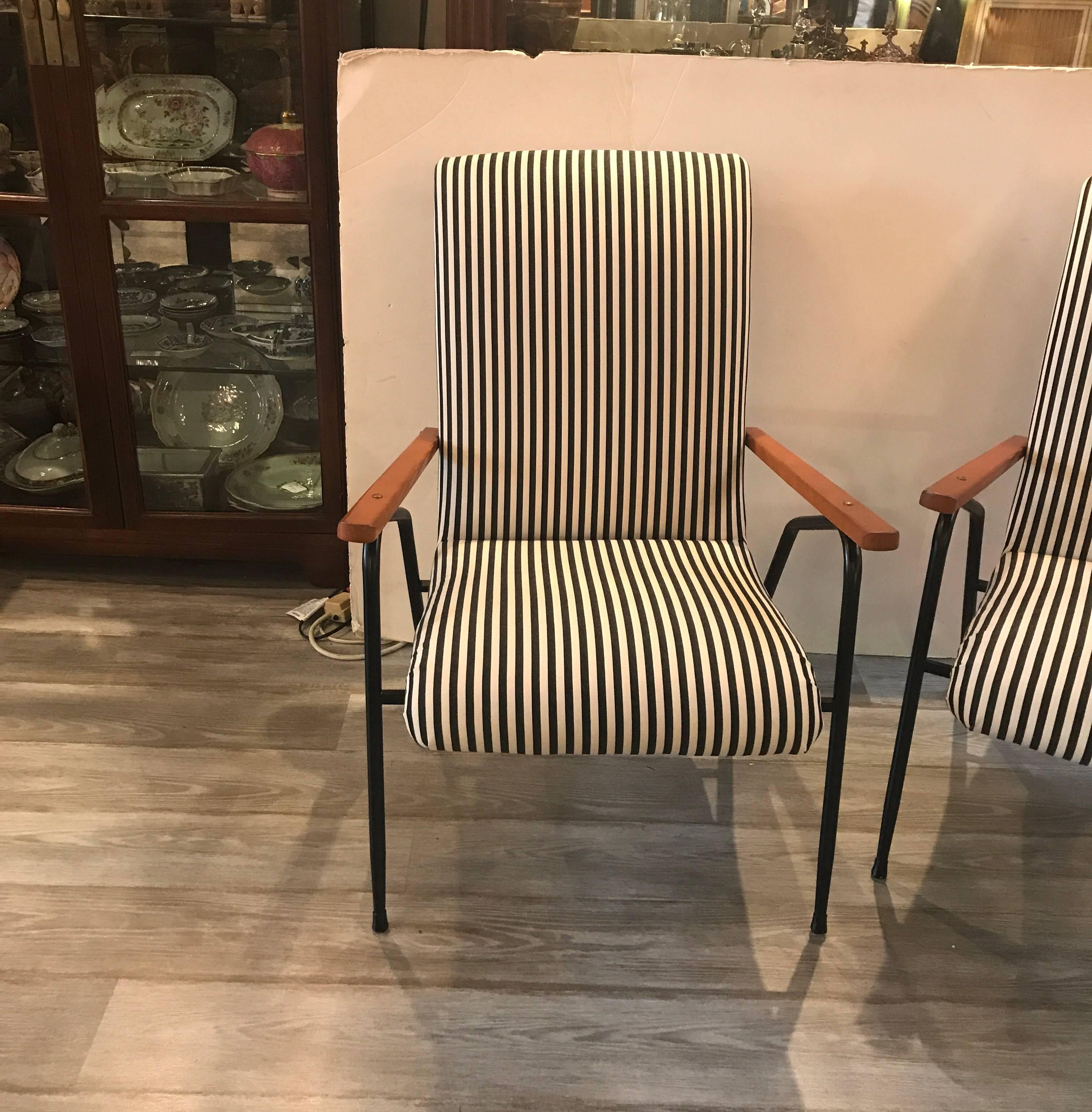 High style and very chic Italian lounge chairs. These were designed for solarium or sun room use originally in the 1950s These are newly covered in a fade and water resistant fabric in a black and off white stripe made by Sunbrella. The black metal