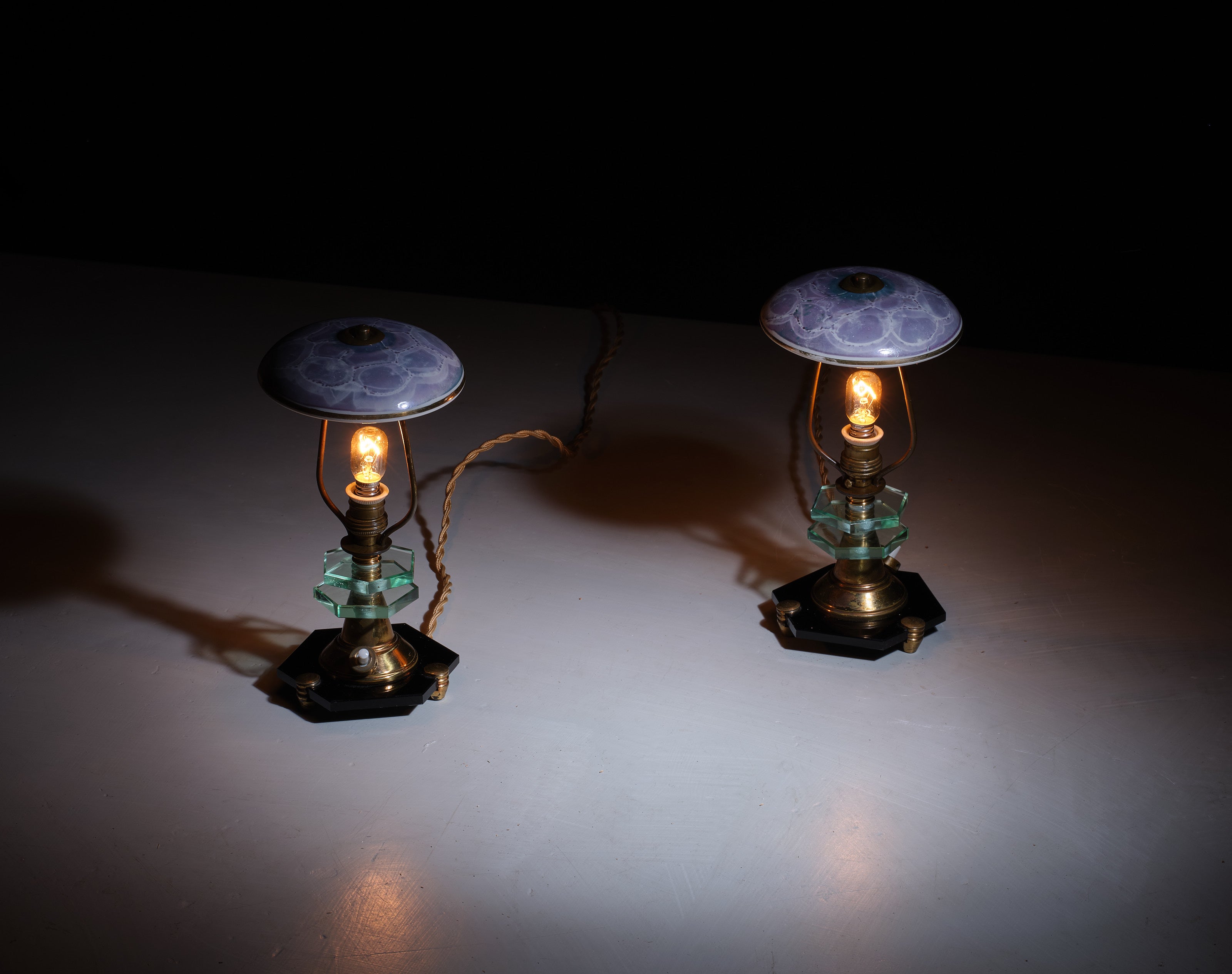 Elevate your decor with this exquisite pair of 1950s Italian table lamps. Designed and crafted in Italy, these lamps are a stunning representation of mid-century production and design. The lamps feature meticulous attention to detail, with brass