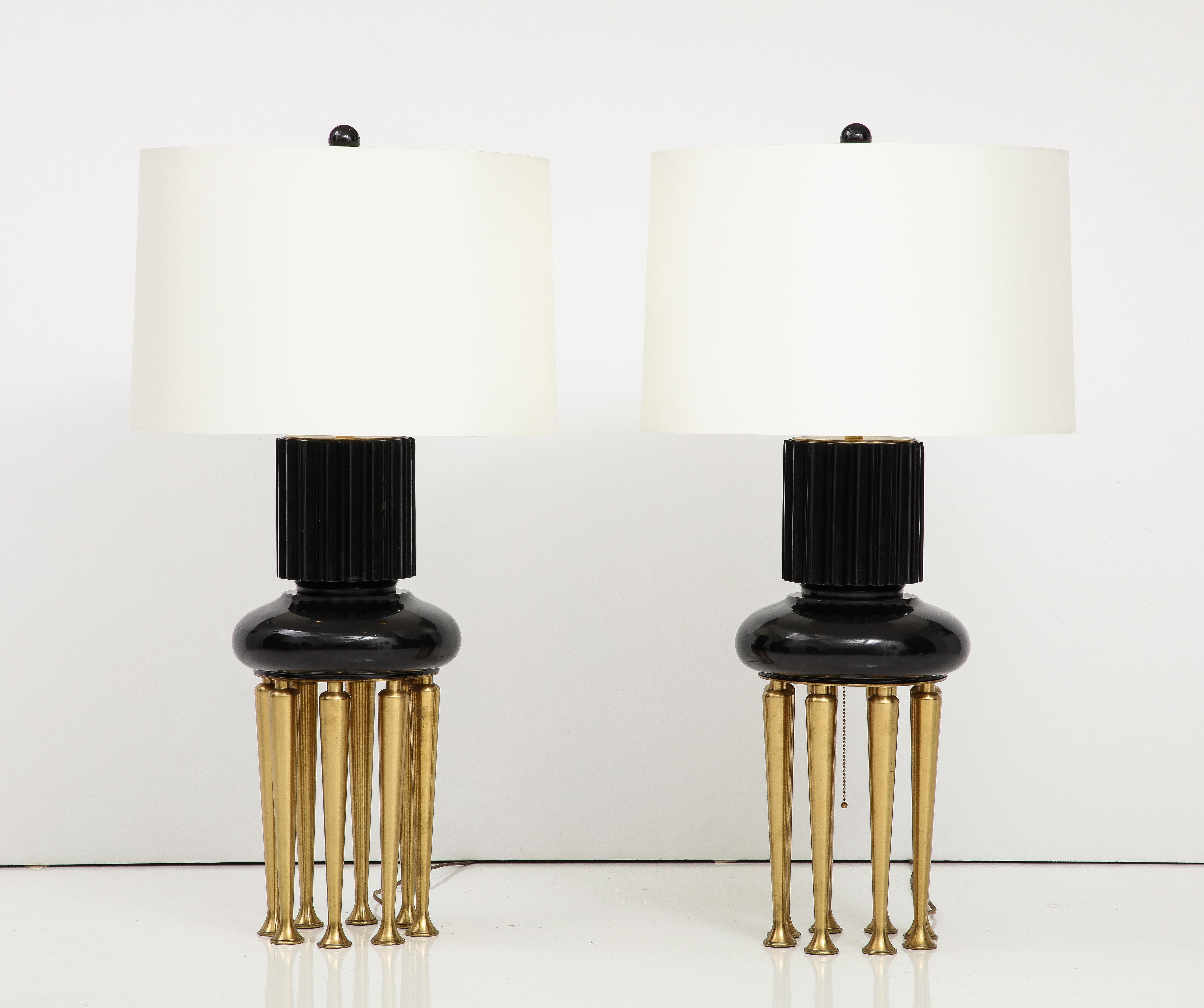 Spectacular Rare pair of 1950's James Mont lamps.
The main lacquered lamp bodies are supported by eight tapered 
brass legs, and they have been Newly rewired for the US with
adjustable polished brass double clusters.
The height off the lamp to
