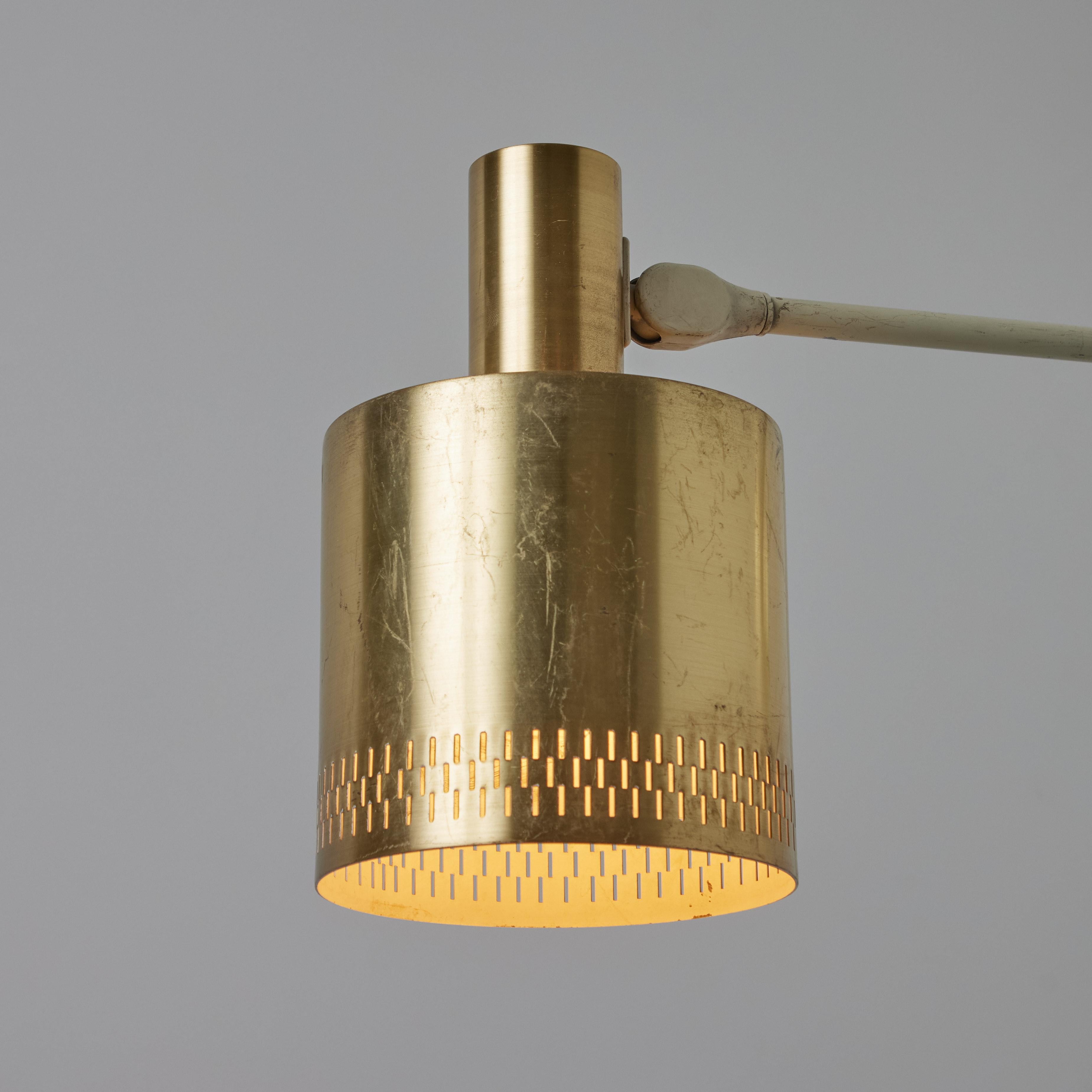 Pair of Large 1950s Jo Hammerborg Perforated Brass Wall Lamps for Fog & Mørup. A minimalist Danish modern design classic executed in brass and white painted metal. A refined pair of wall lamps that is quintessentially Scandinavian. Unmarked.

Fog
