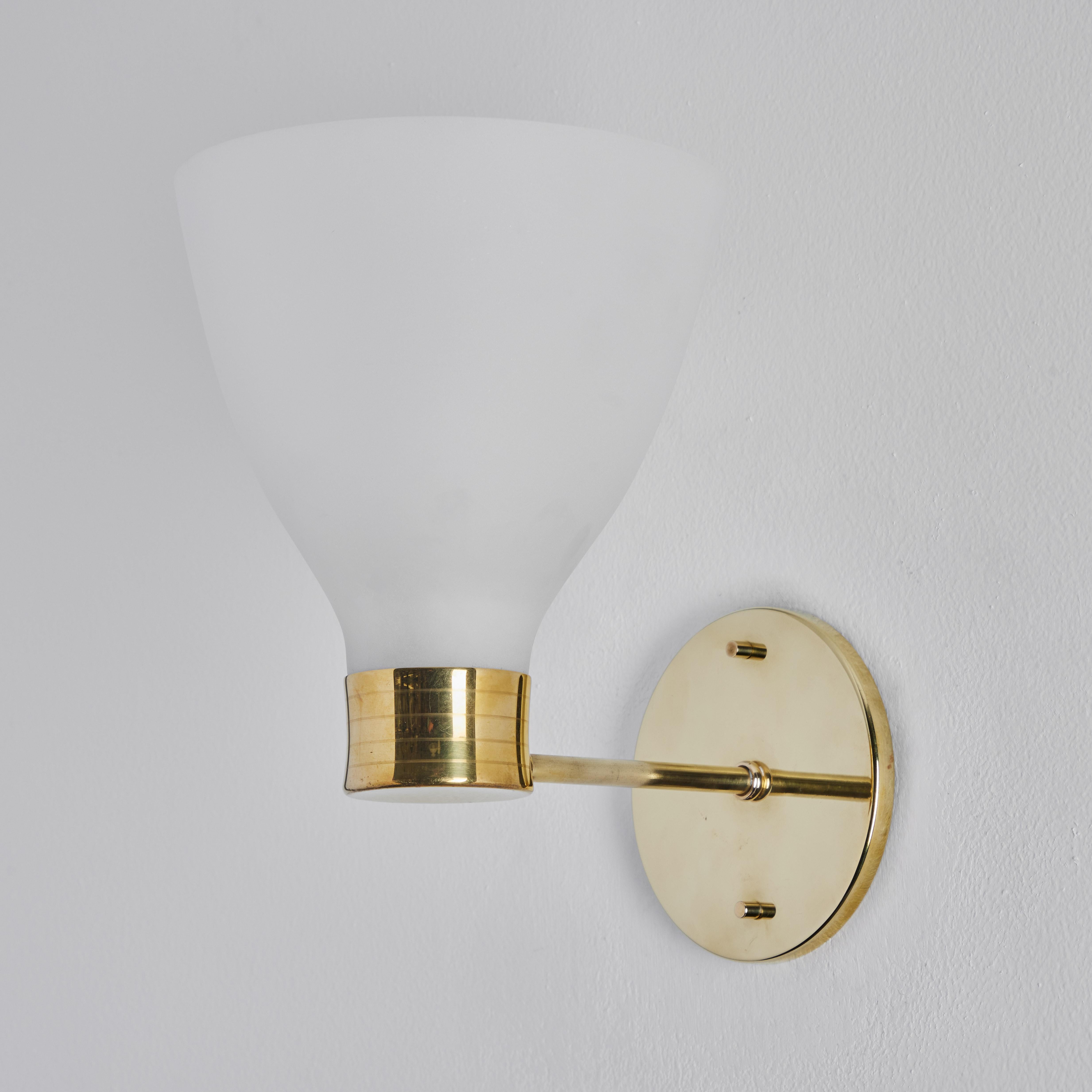 Pair of 1950s Lisa Johansson-Pape glass & brass wall lamps. Executed in matte opaline white glass and brass.

Price is for the pair.

A contemporary of Paavo Tynell, the refined work of Lisa Johansson-Pape has made her an increasingly valued