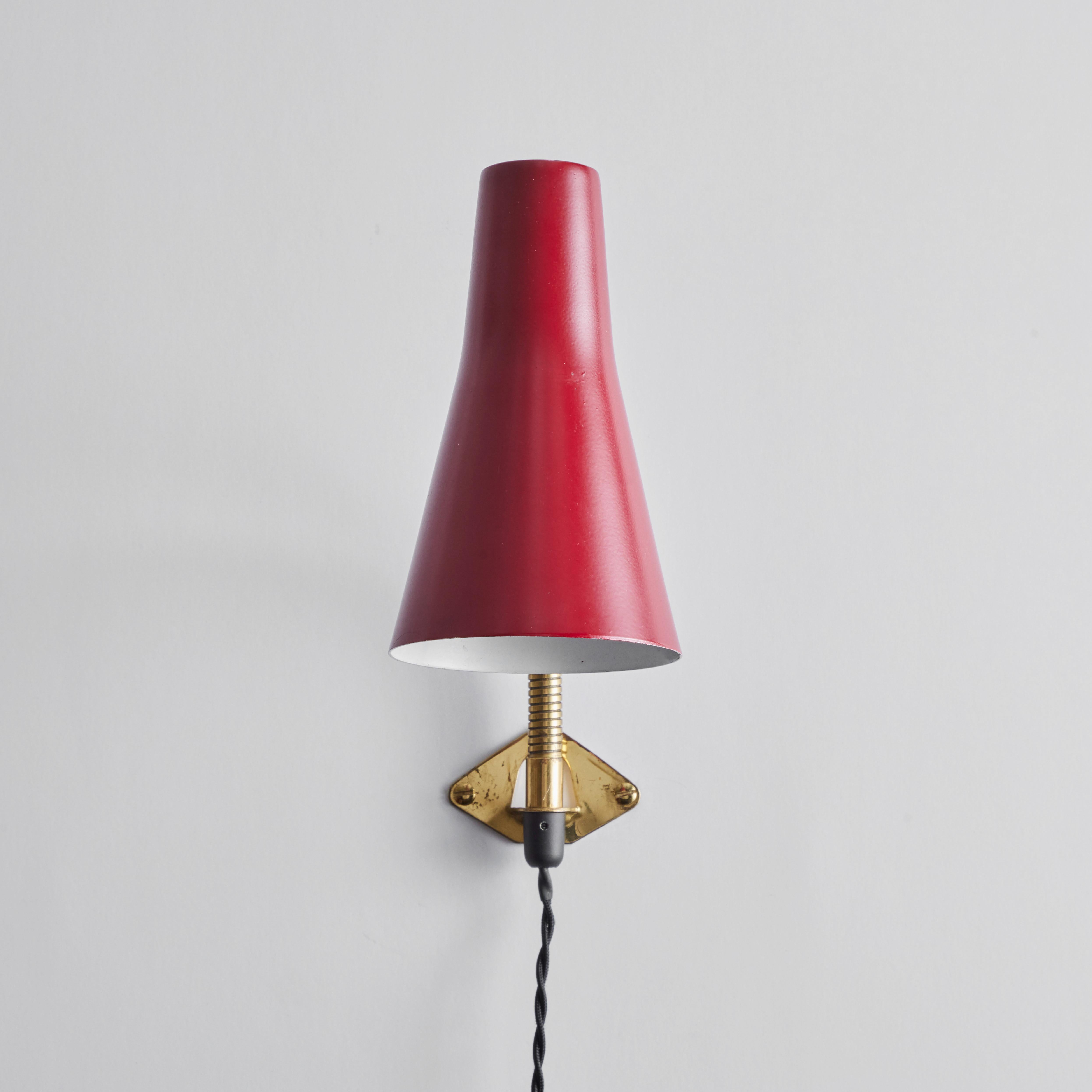 Pair of 1950s Lisa Johansson Pape Red Adjustable wall lights for Stockmann Orno. A versatile pair of adjustable wall lights, the brass gooseneck arm with shade can be raised and lowered as well as rotated right and left. The articulating arm can be