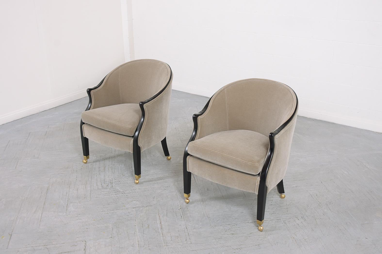 An extraordinary pair of lounge chairs by Baker is beautifully hand-crafted out of mahogany wood in great condition and have been fully restored refinished and upholstered by our expert craftsmen team. This 1950s pair of armchairs features a solid