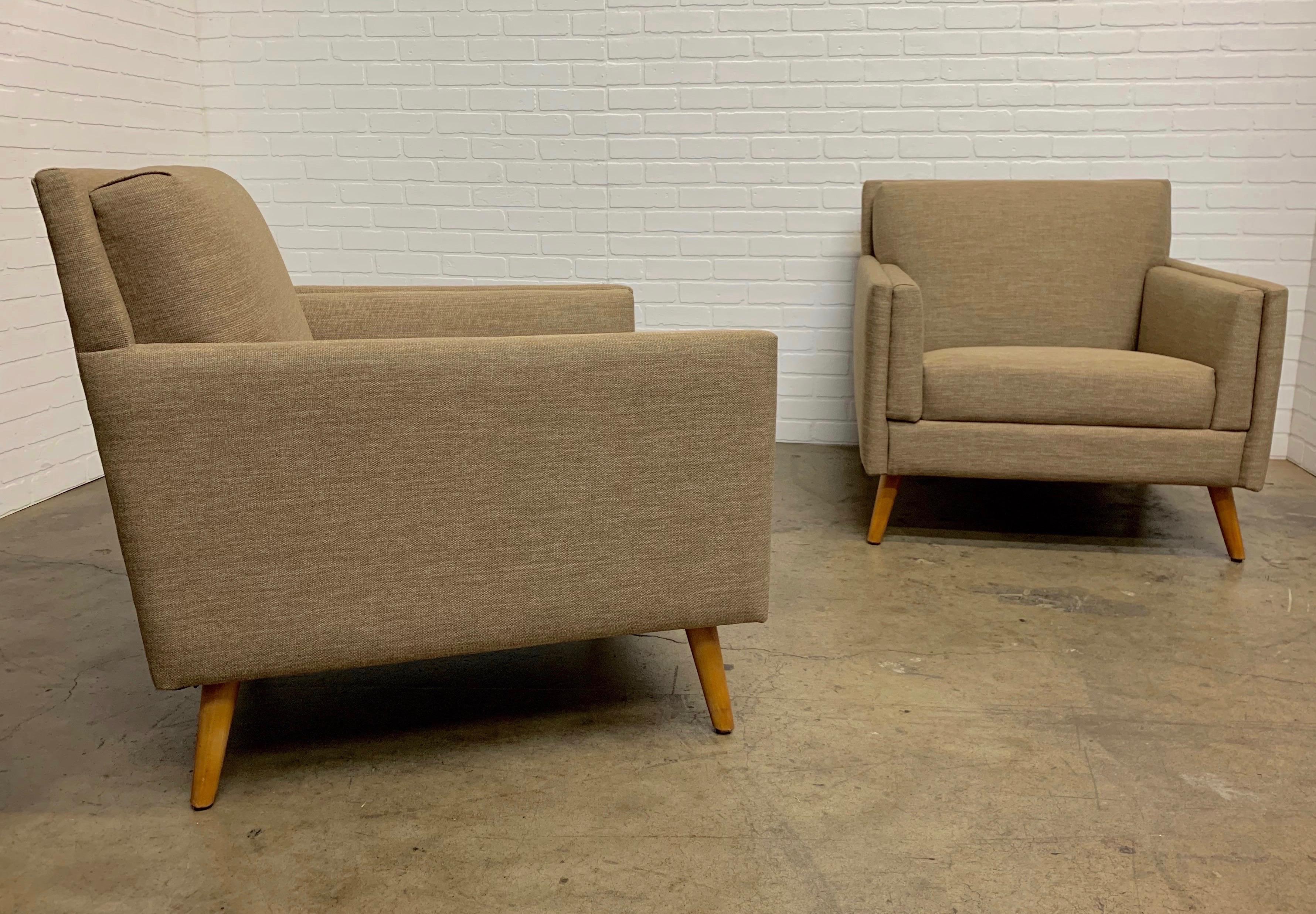 Paul McCobb style chairs very angular with sharp edges and sprawled maple legs and new firm upholstery.