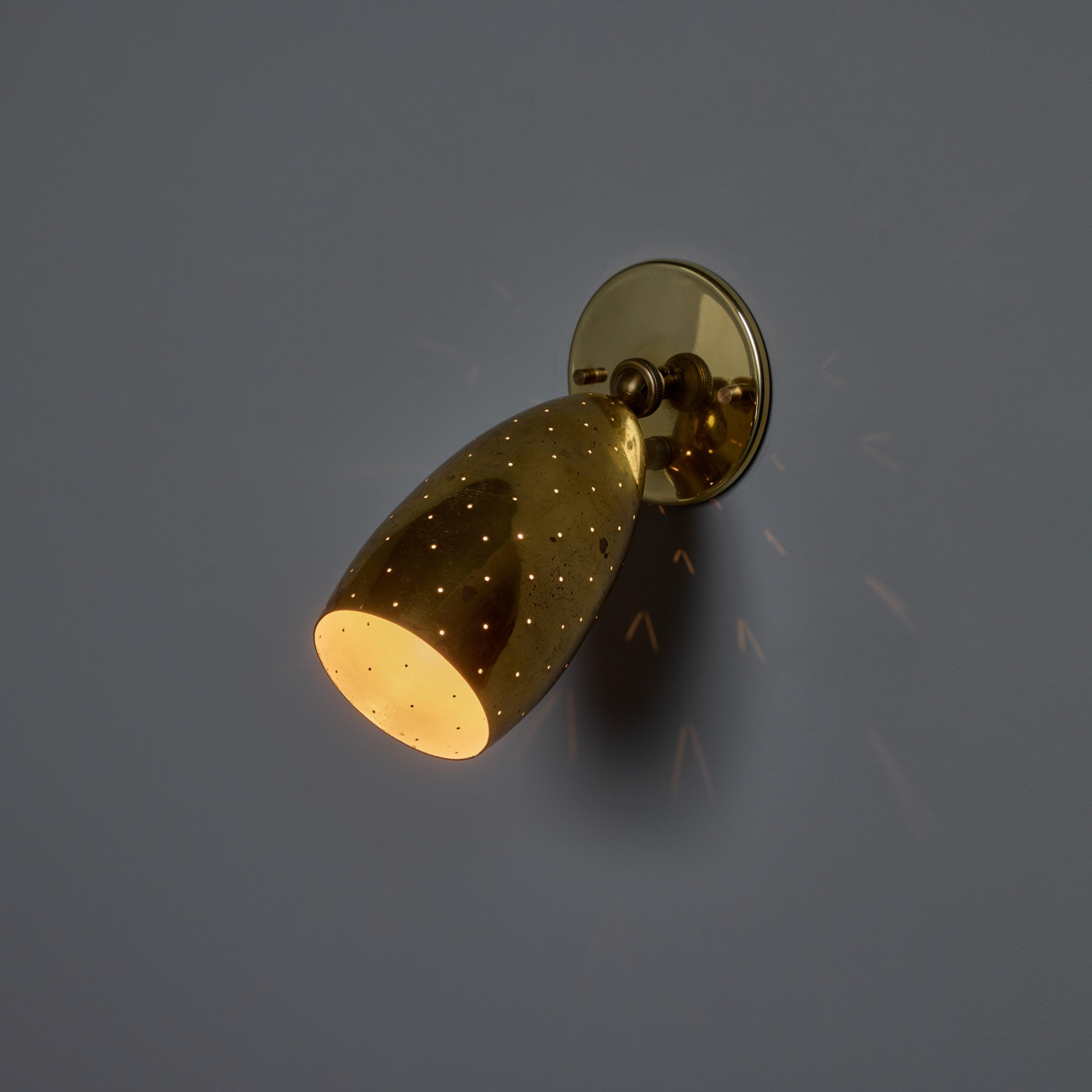 A contemporary of Paavo Tynell, the refined work of Mauri Almari has made him an increasingly valued midcentury Finnish designer by collectors in the know. Executed in beautifully patinated brass with perforations that create a stunning pattern of