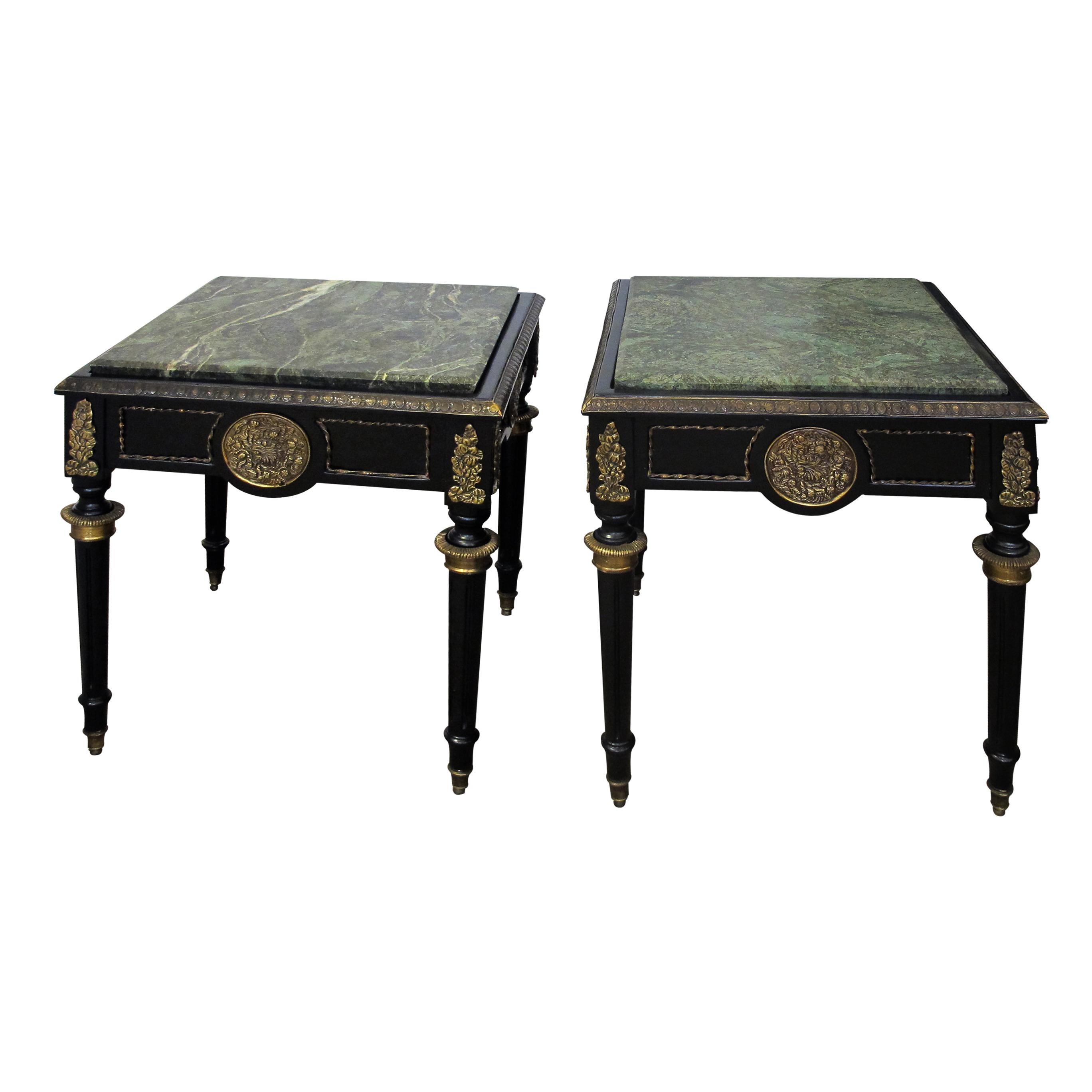 An elegant pair of mid century French black side tables with green marble inserted into their tops. The side tables are decorated with bronze gilded 'ormolus’ and presented on four tapered legs with bronze gilded collarette fittings and brass caps