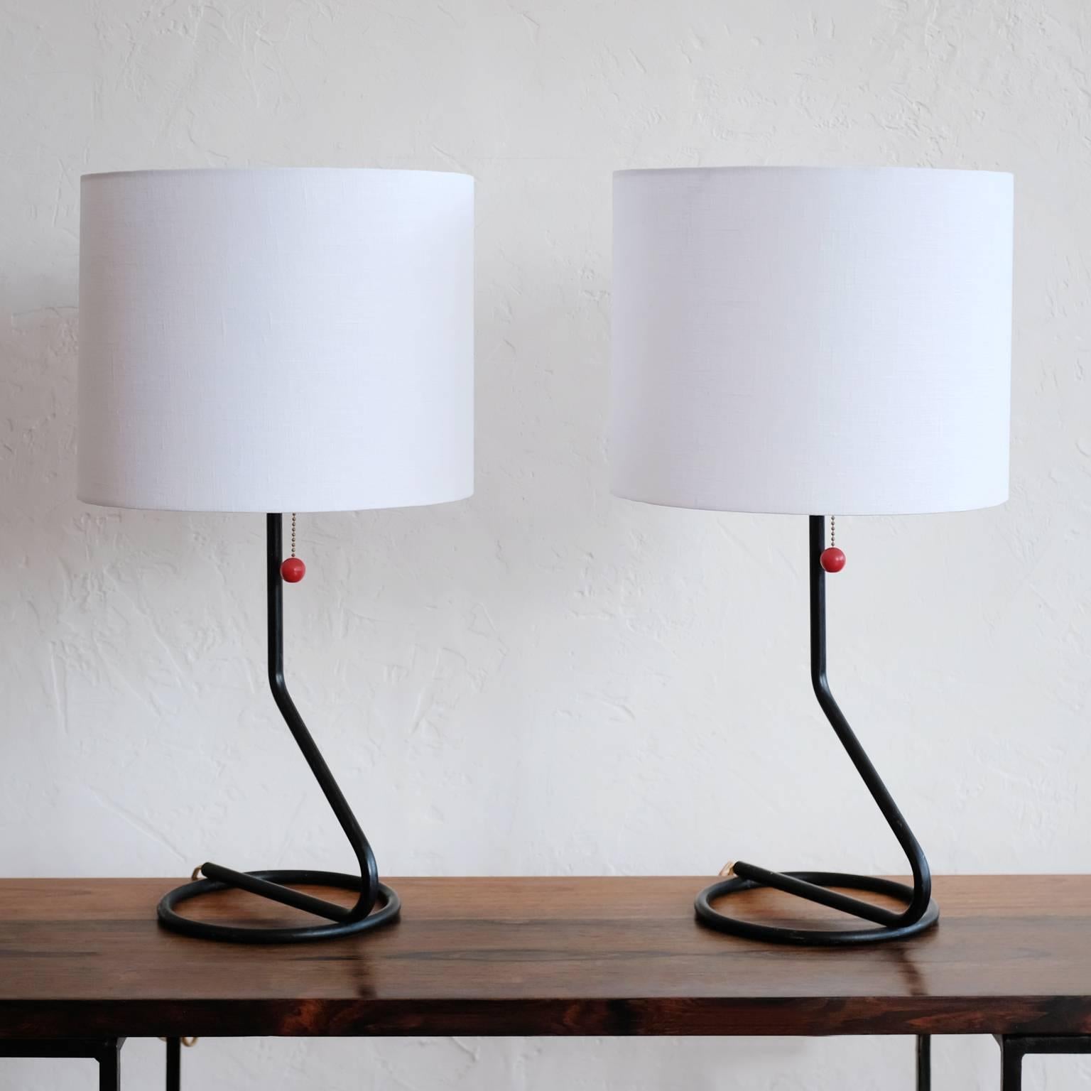 A pair of minimalist table lamps from the 1950s. Great geometric form. New sockets, harps and US Made linen shades. 

Shades: 12 wide x 10