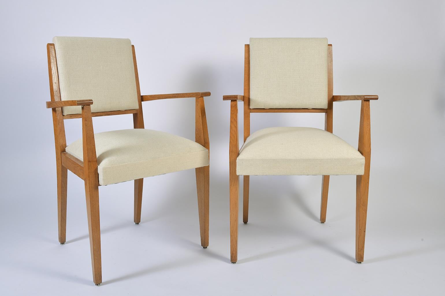 A pair of Post War blond oak armchairs.
France, circa 1950.

 