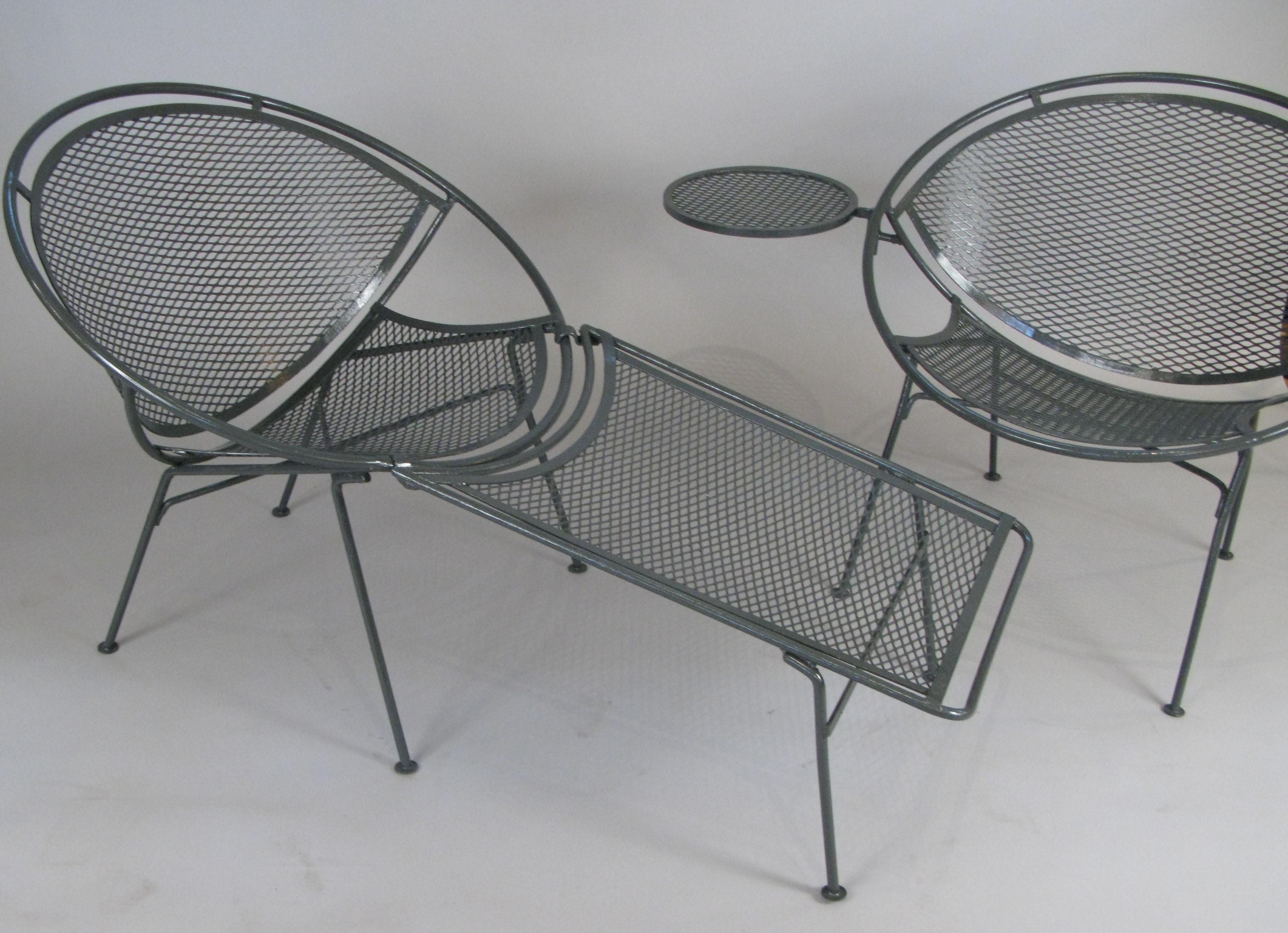 A matched pair of vintage 1950s wrought iron lounge chairs from Maurizio Tempestini's Radar collection for Salterini. One of the most well designed series from this era, the chairs are extremely comfortable with a round frame and panels of steel