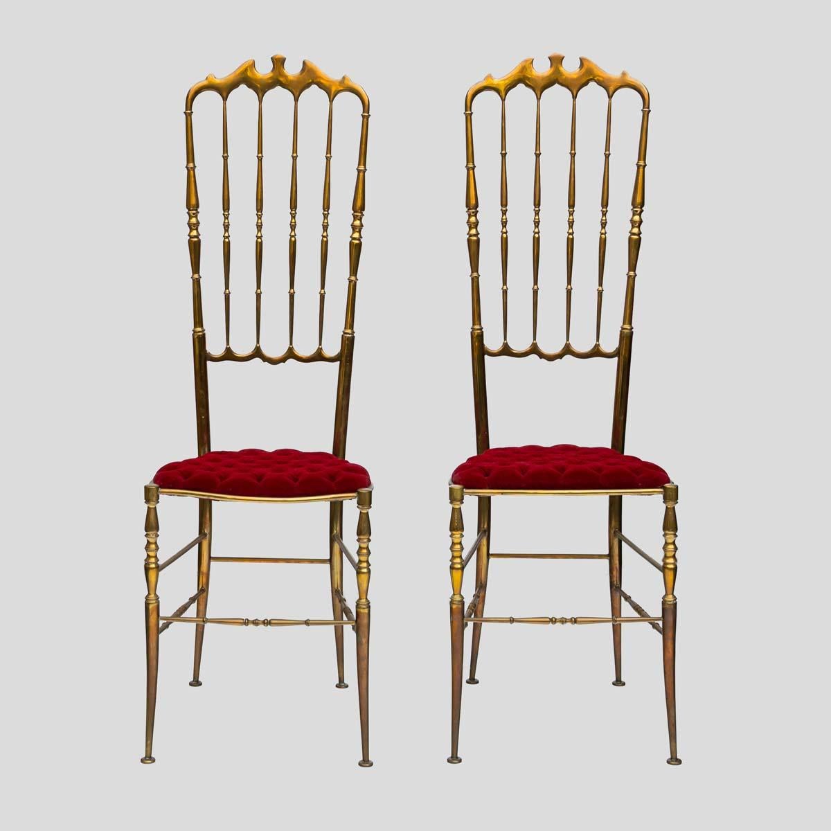 Pair of 1950s high-back chairs by Chiavari, featuring red velvet upholstery and brass metal frames.