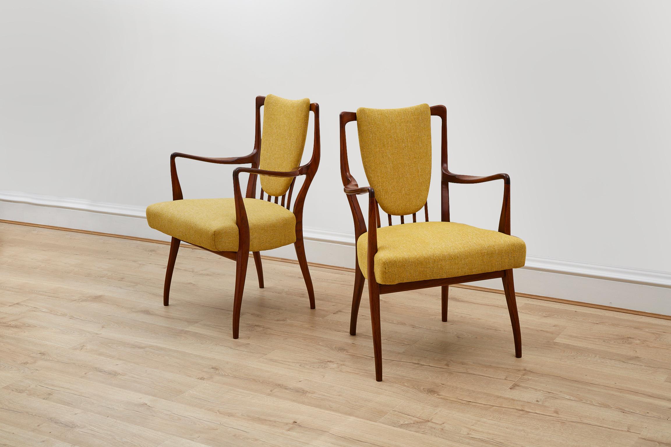 A lovely and rare pair of side chairs by A.J Milne. Handmade in England by Heals in the 1950’s. Rosewood frames are recently reupholstered in a mustard fabric.

A.J. Milne, also known as Andrew J. Milne, served as the Chief Designer for Heal & Son,