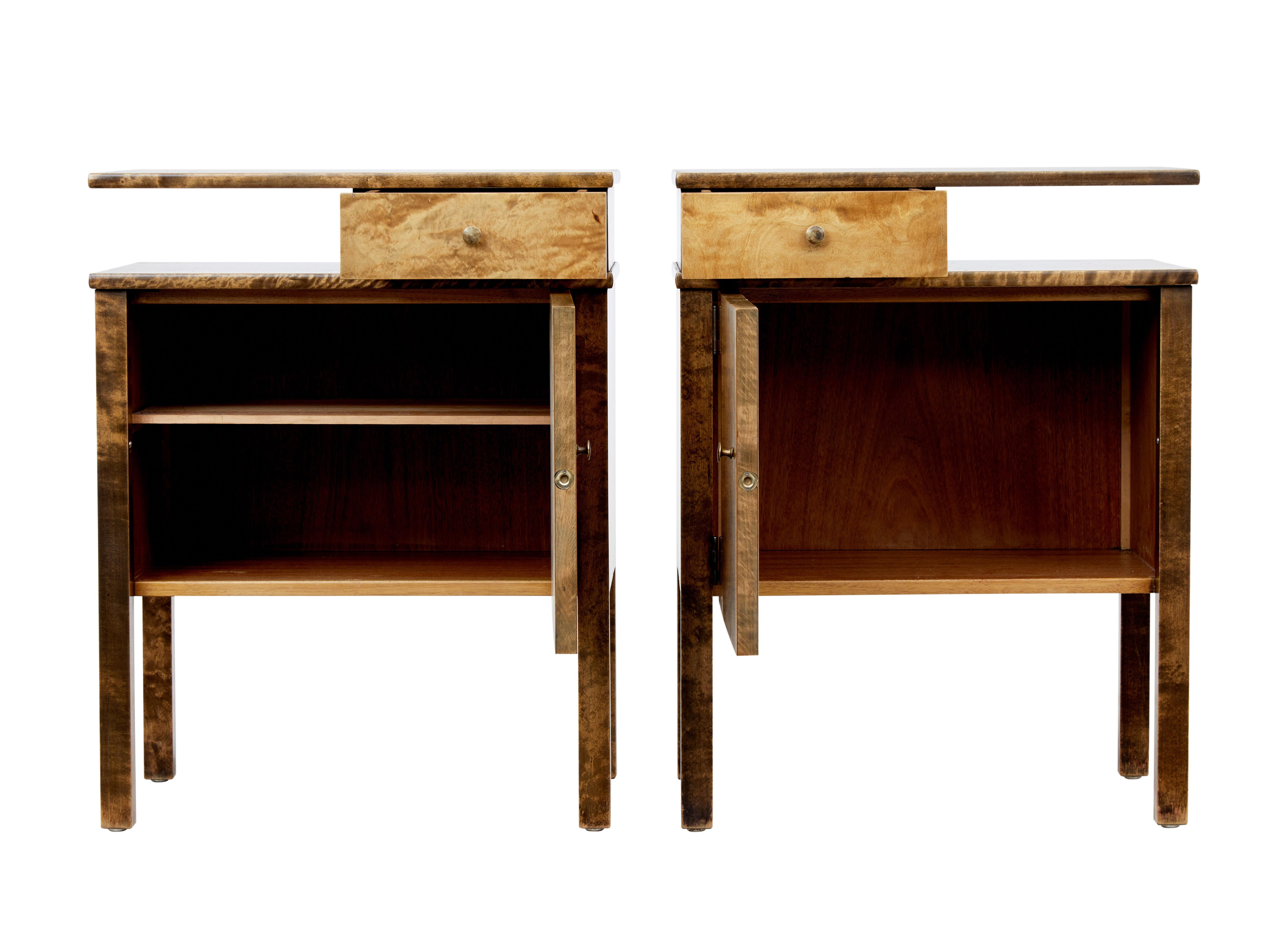 Pair of bedside tables in the deco taste circa 1950.

Floating top surface with small drawer below, with open space for storage. Single door cupboard with matched veneers to the front, 1 cupboard containing a shelf.

Made with contrasting dark